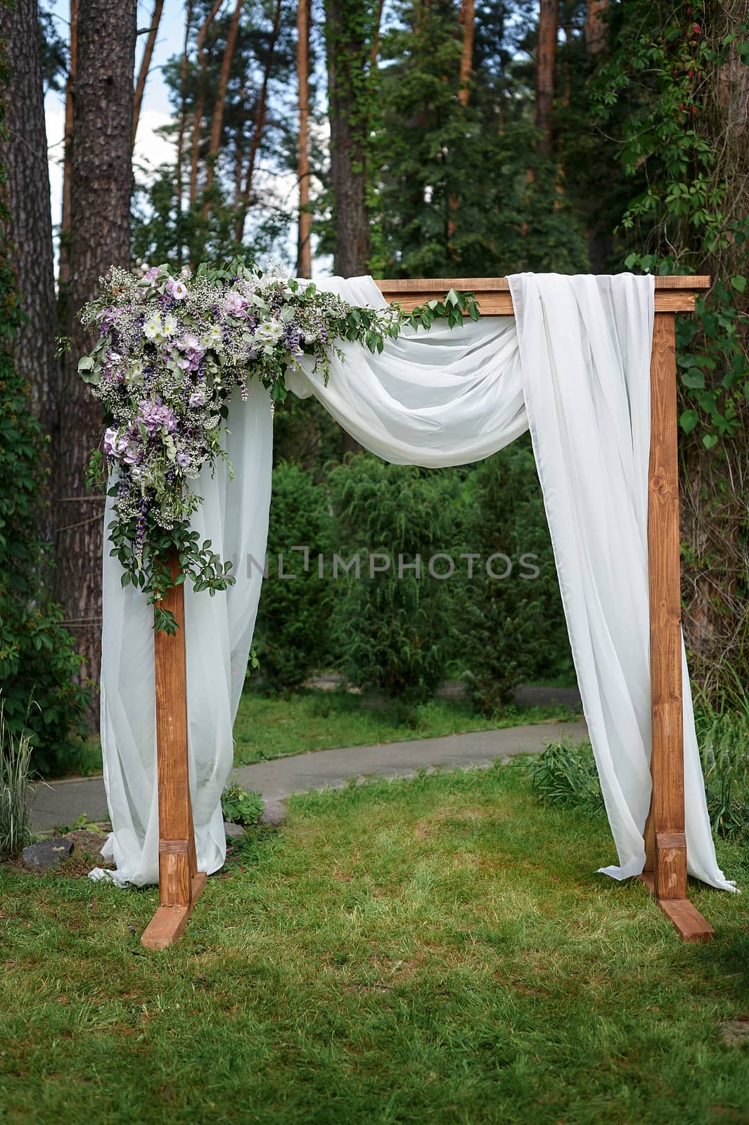 Beautiful wedding arch decorated with flowers in the Park.