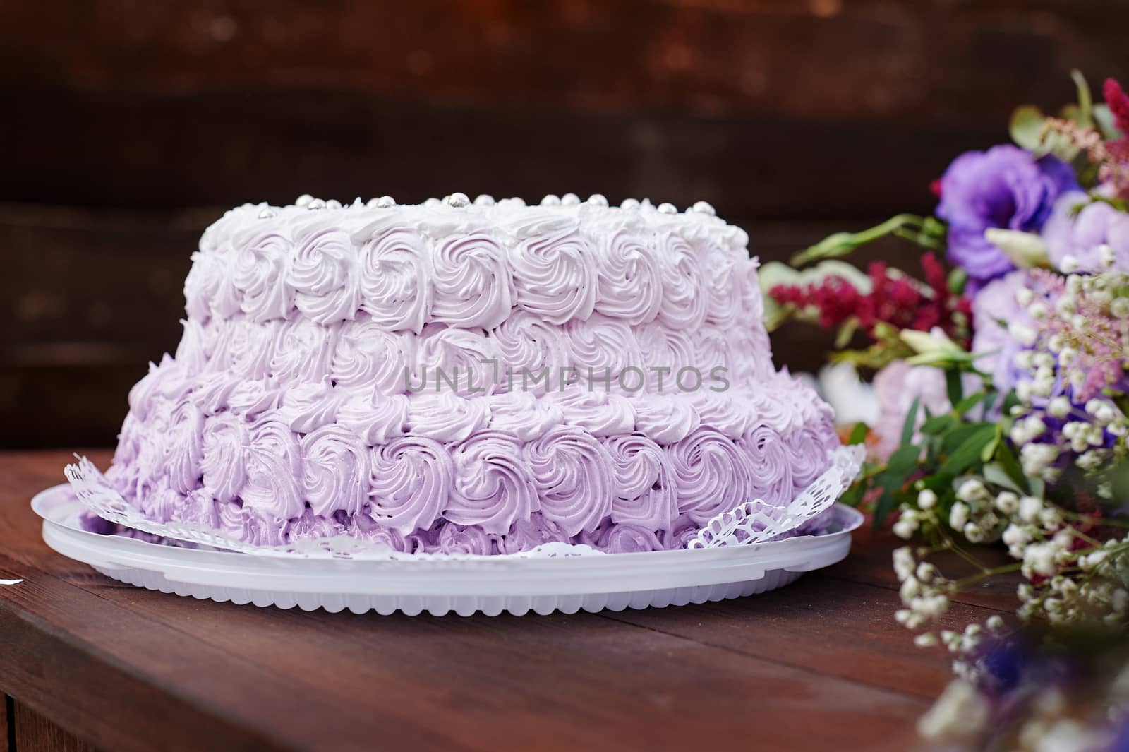 festive wedding cake and a bouquet of flowers on the table.