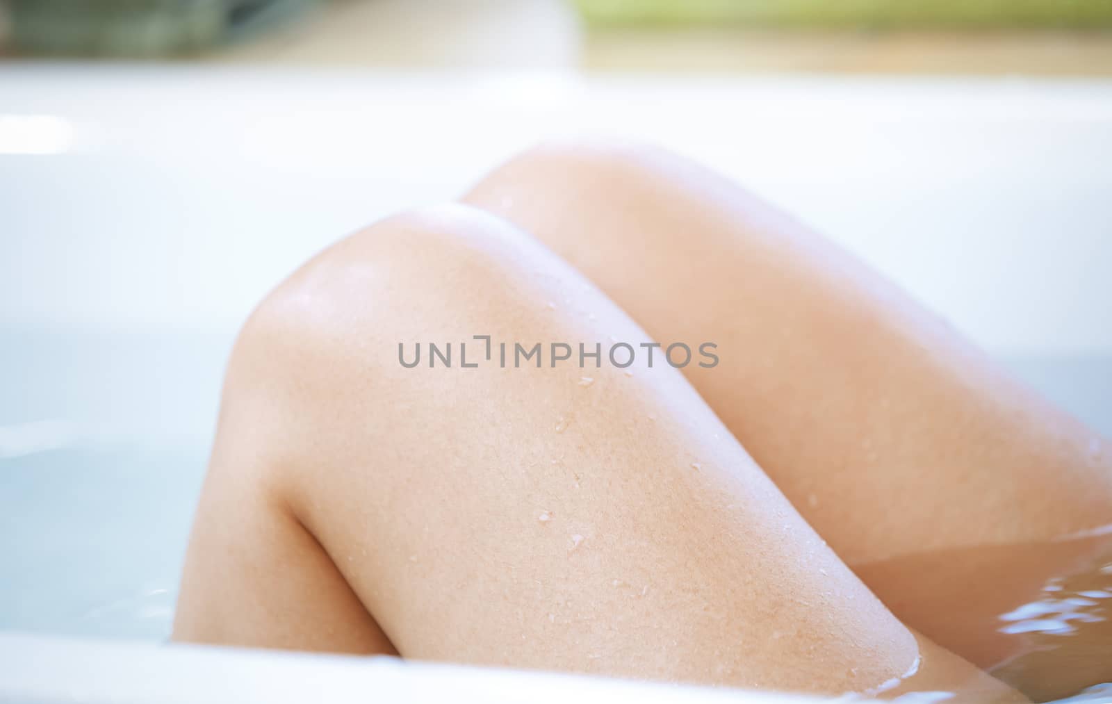 Wet knees of the woman taking a bath