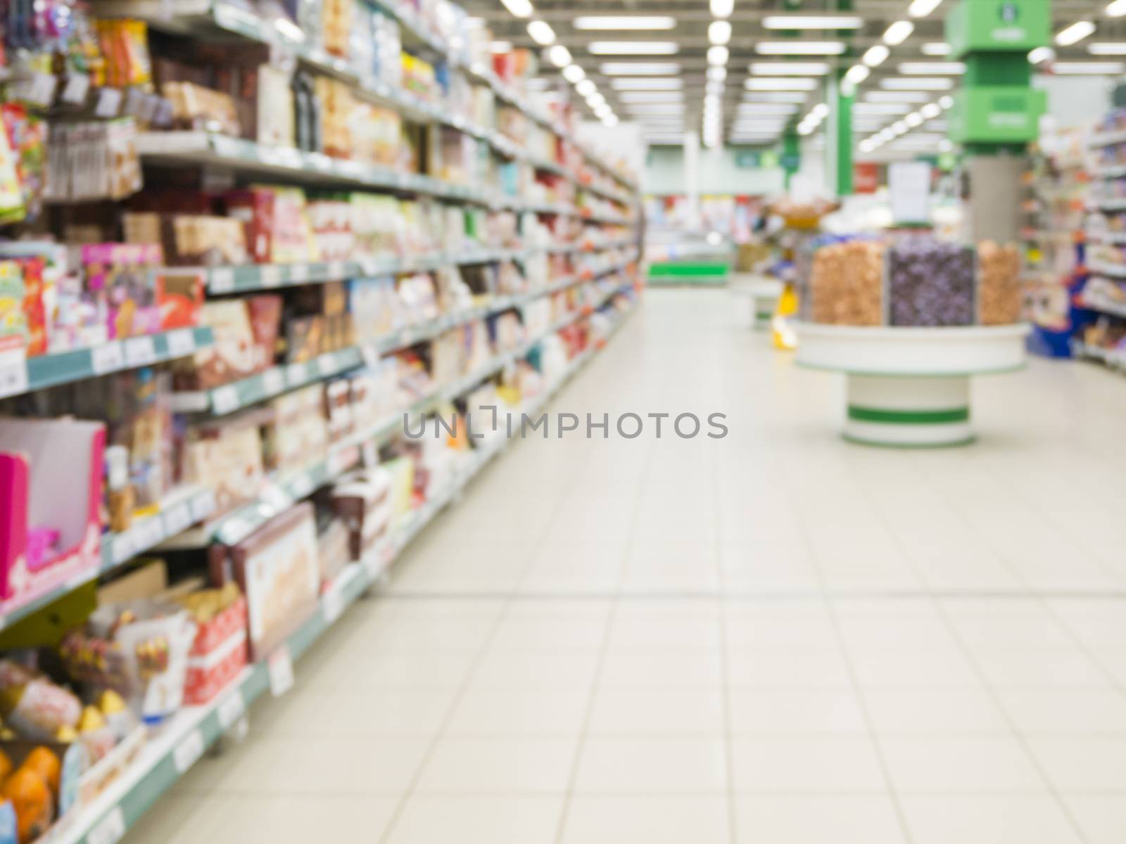 Abstract blurred supermarket aisle with colorful shelves as background