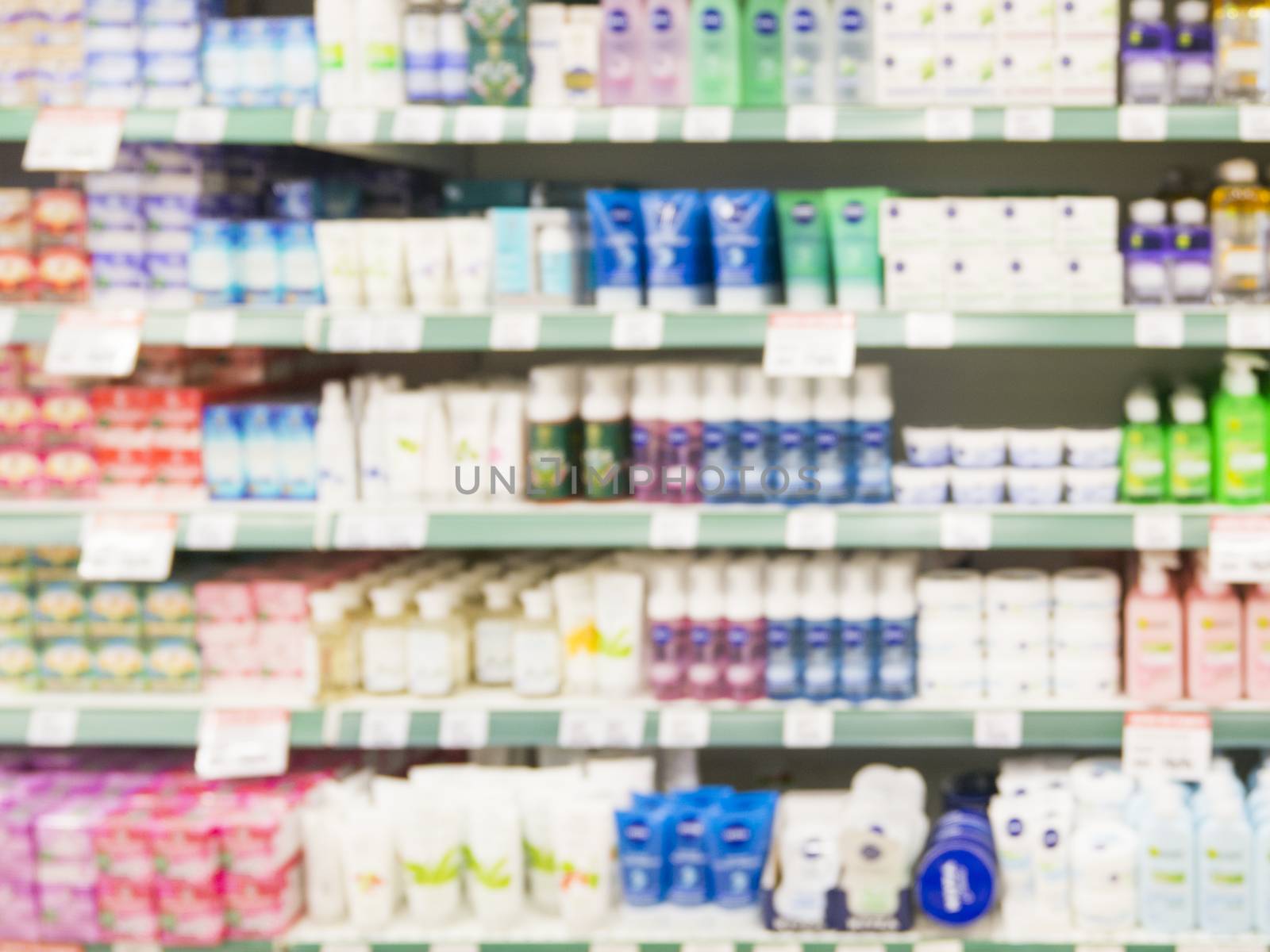 Abstract blurred supermarket shelf with colorful cosmetic goods as background