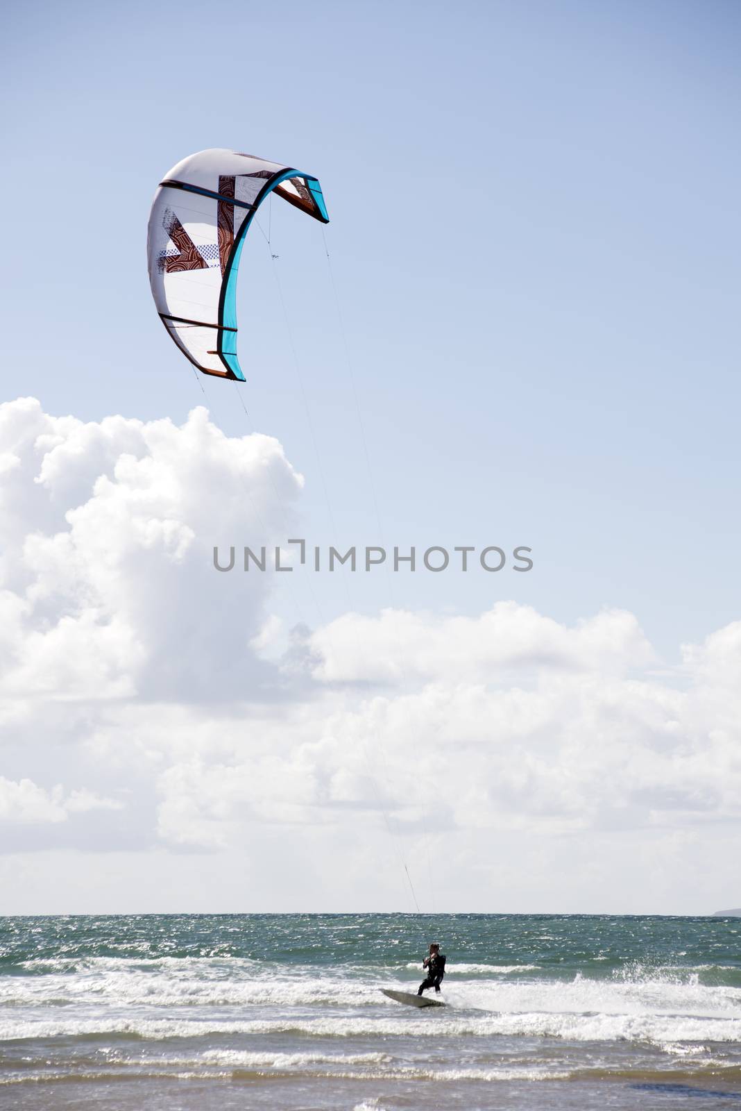 fast kite surfer on beautiful waves by morrbyte