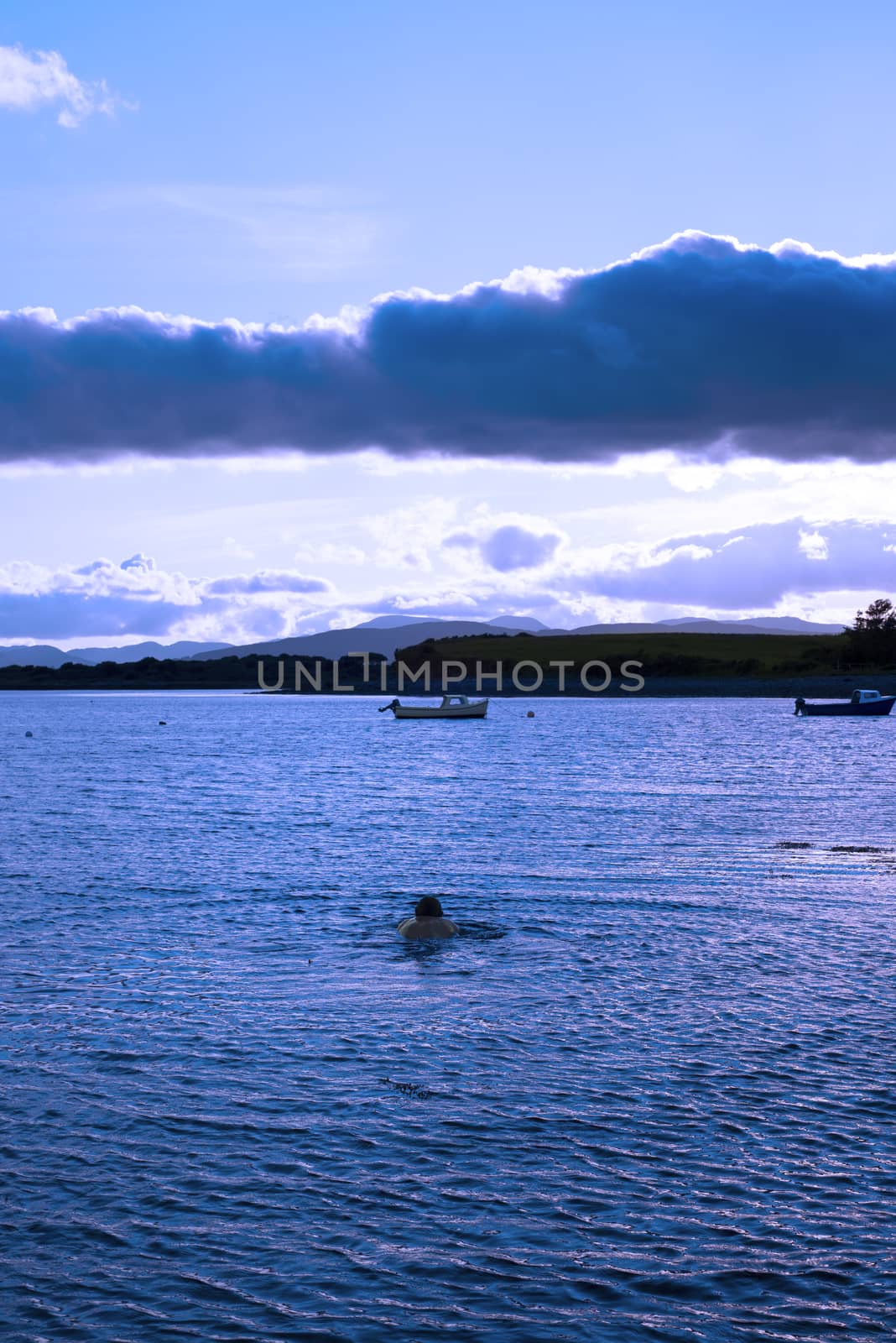 man swimming in a quiet bay near kenmare by morrbyte