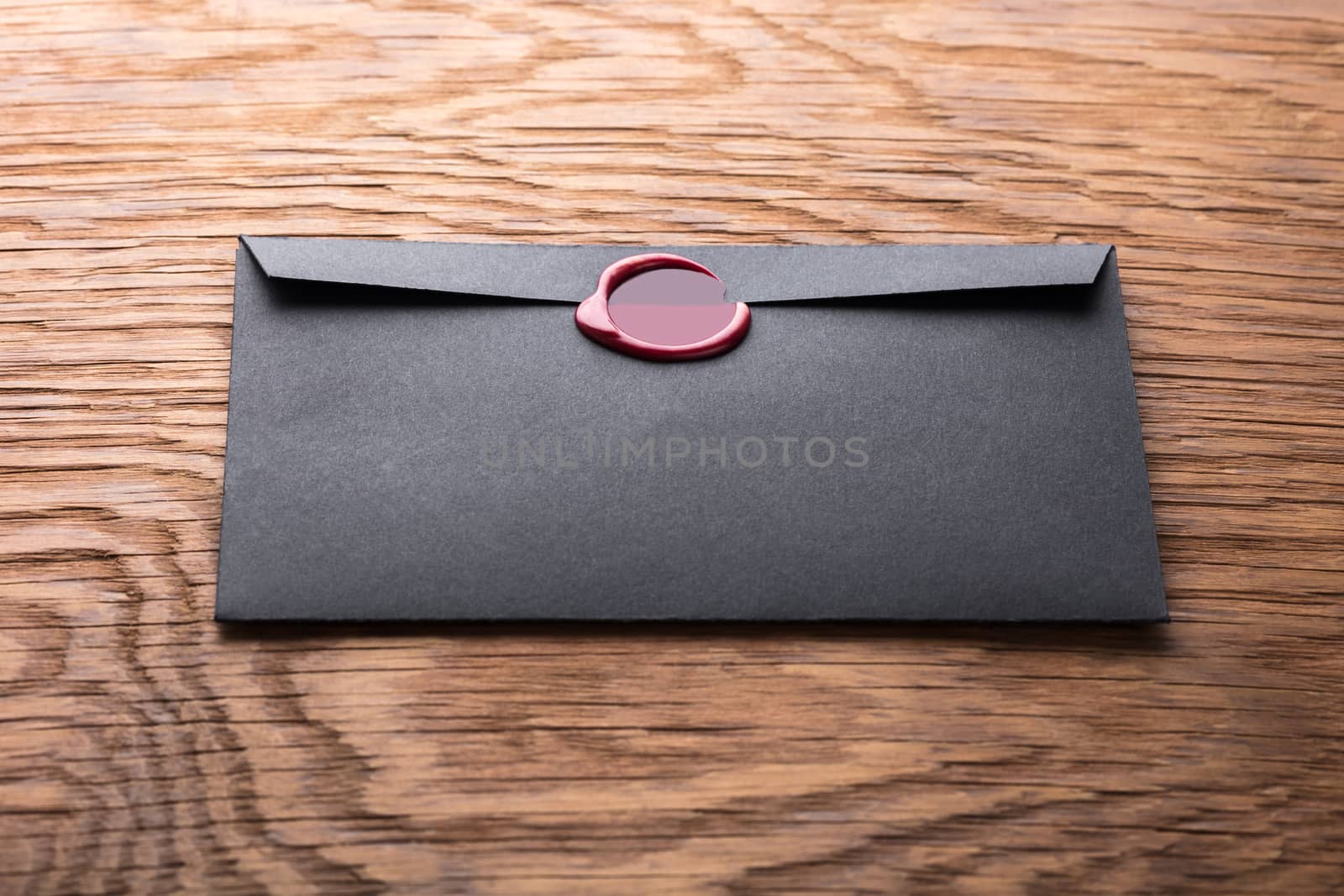 envelope with a stamp on the wooden background