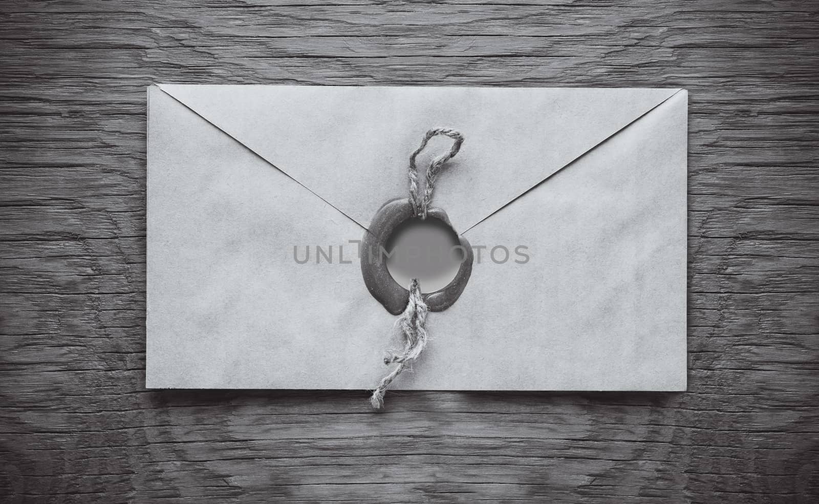 envelope with a stamp on the wooden background