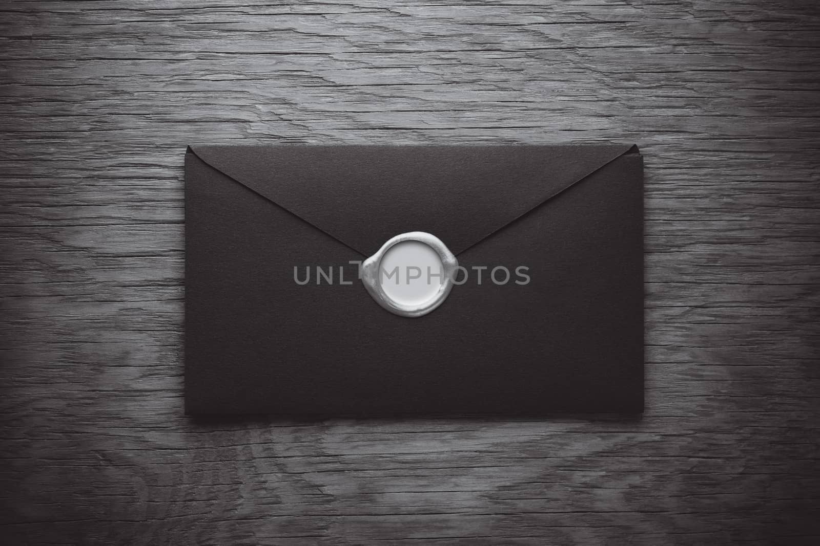 envelope with a stamp on the wooden background