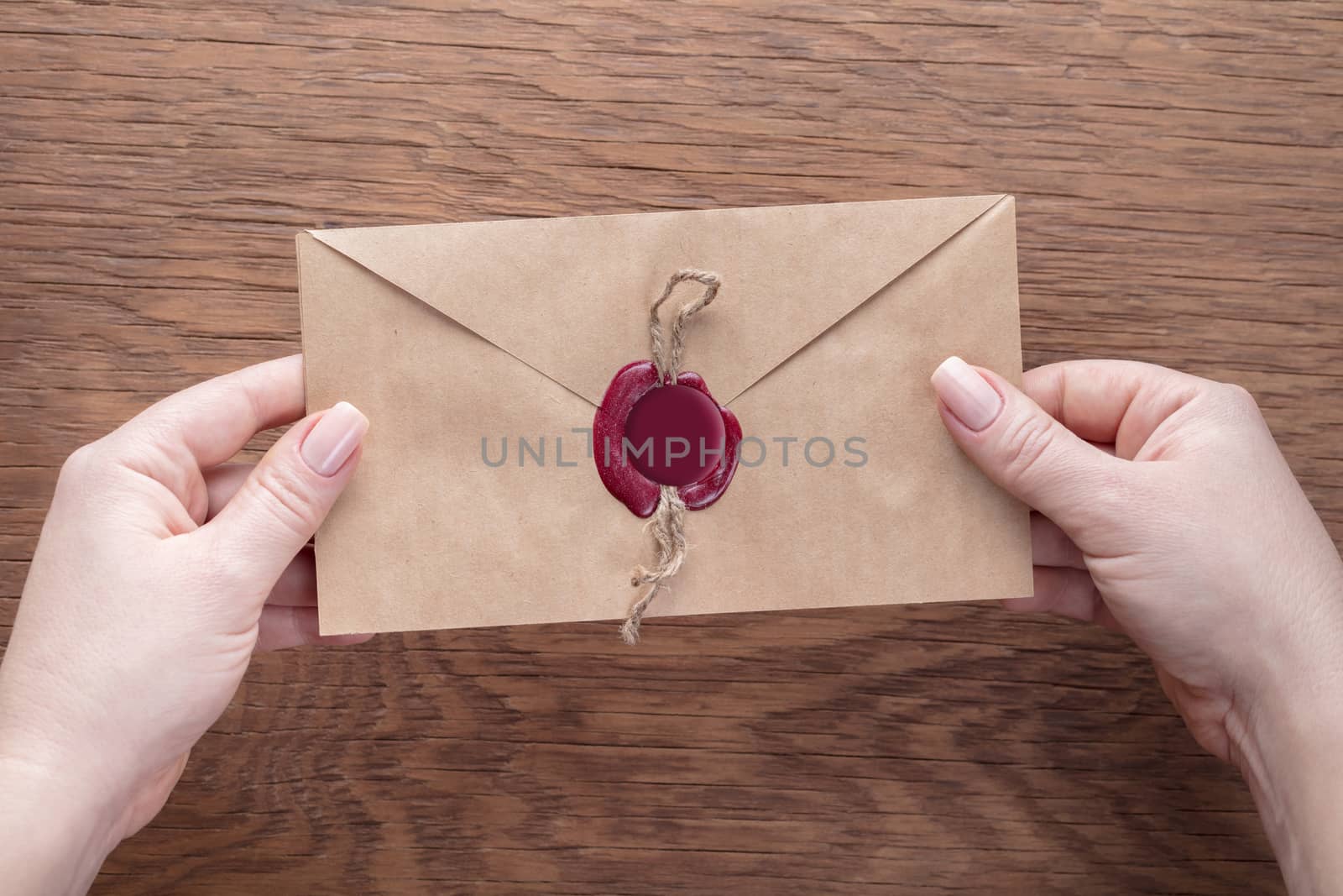 envelope in the hands on a wooden background