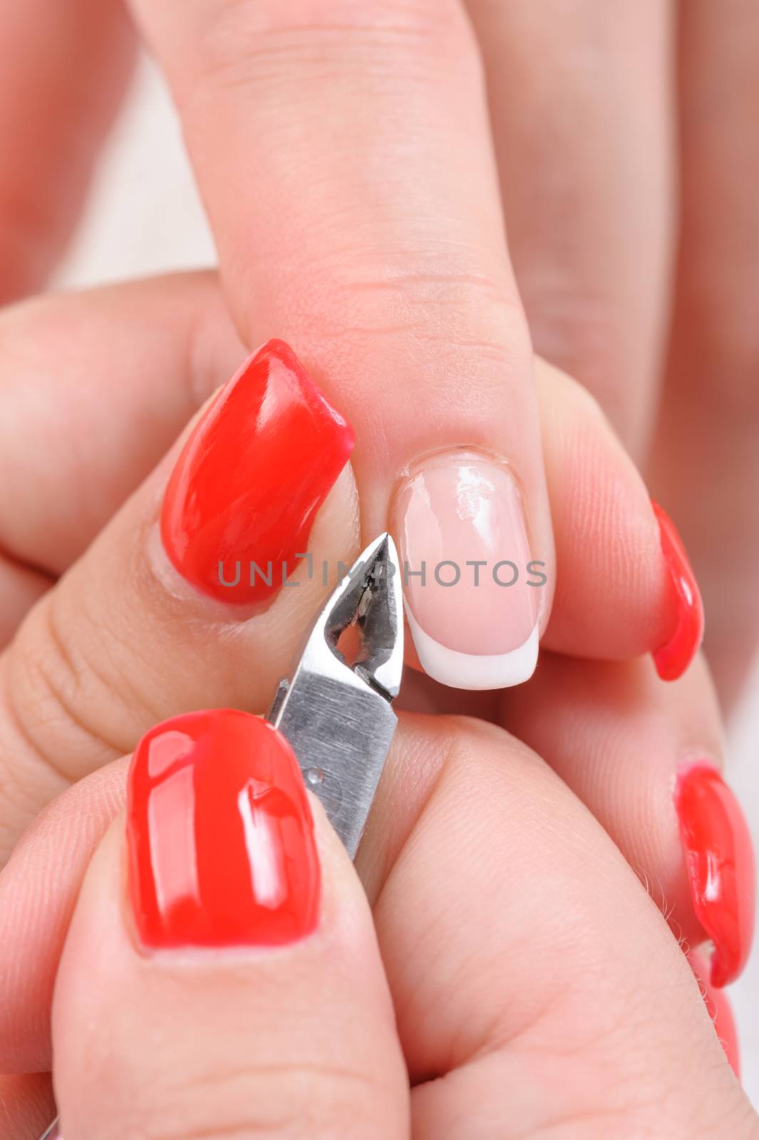 Nail salon, hands beauty treatment, cuticles cutting with nail clippers