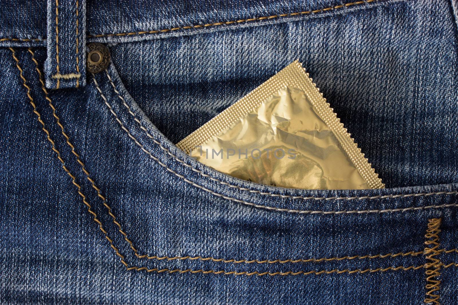 condom in a pocket of blue jeans