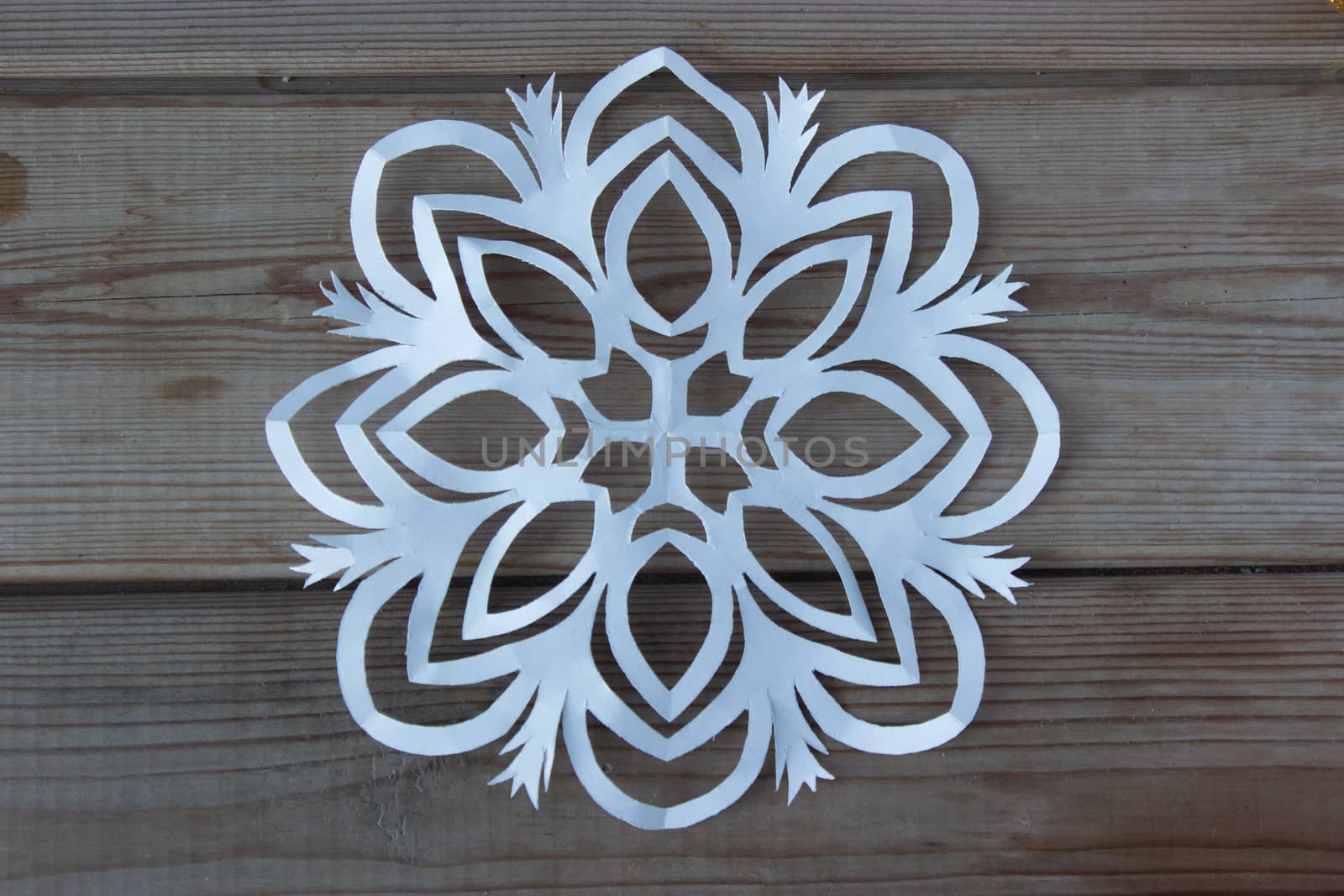 paper snowflake on the wooden table by liwei12