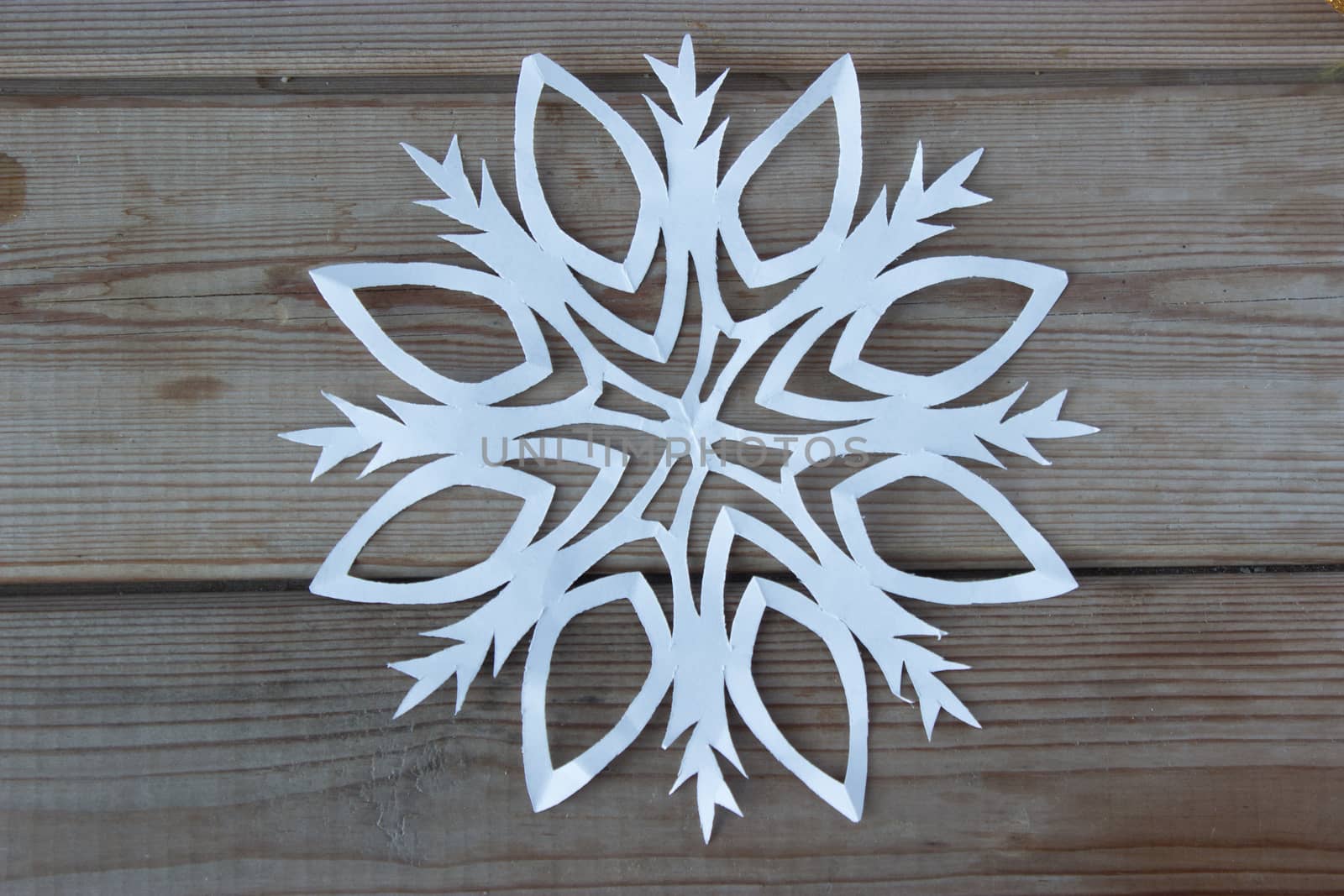 paper snowflake on the wooden table by liwei12