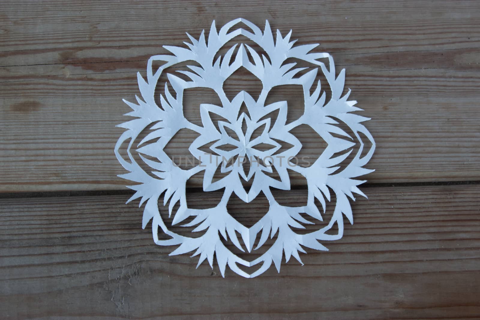 paper snowflake on the wooden table by liwei12