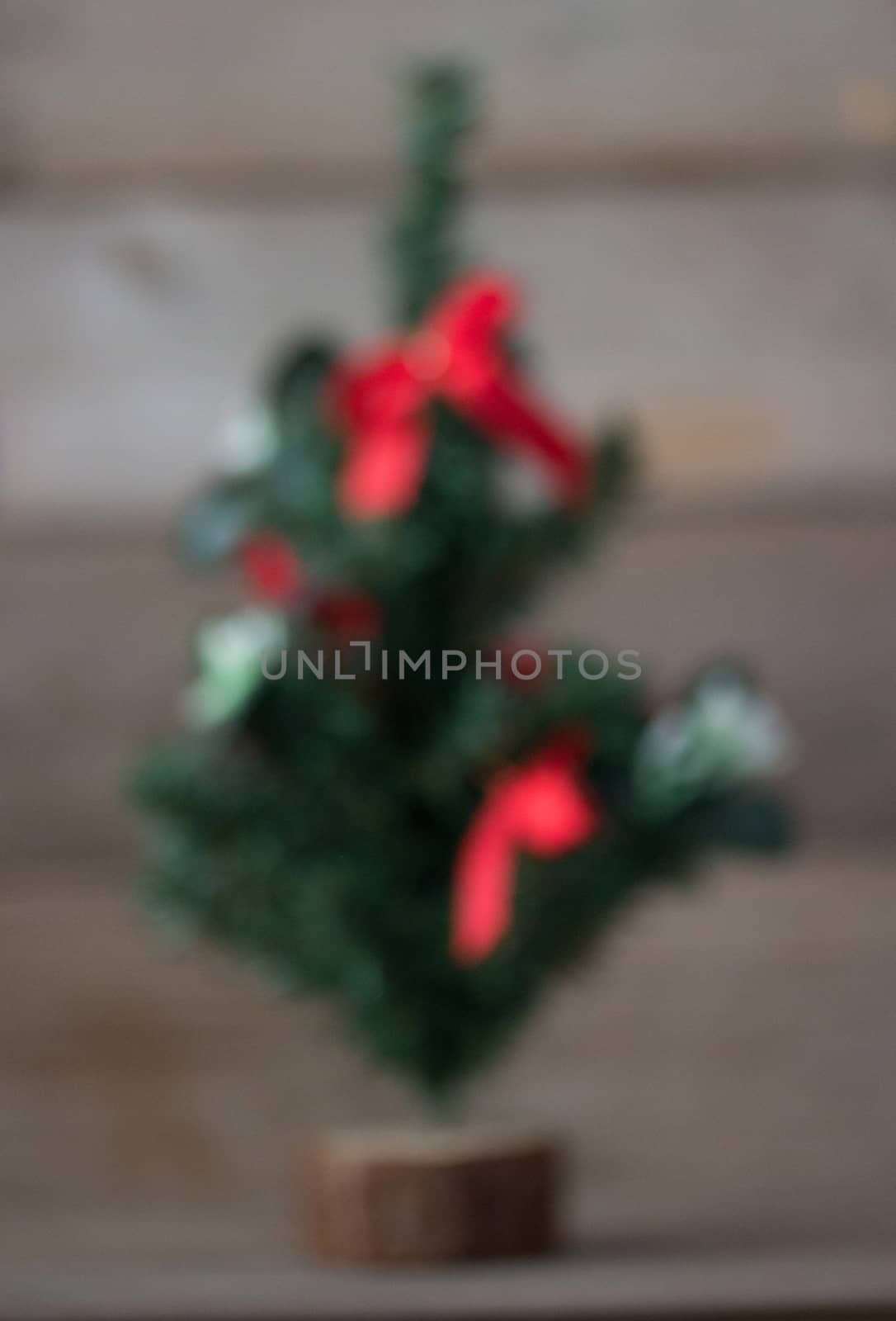 blured Christmas tree with red decorations background