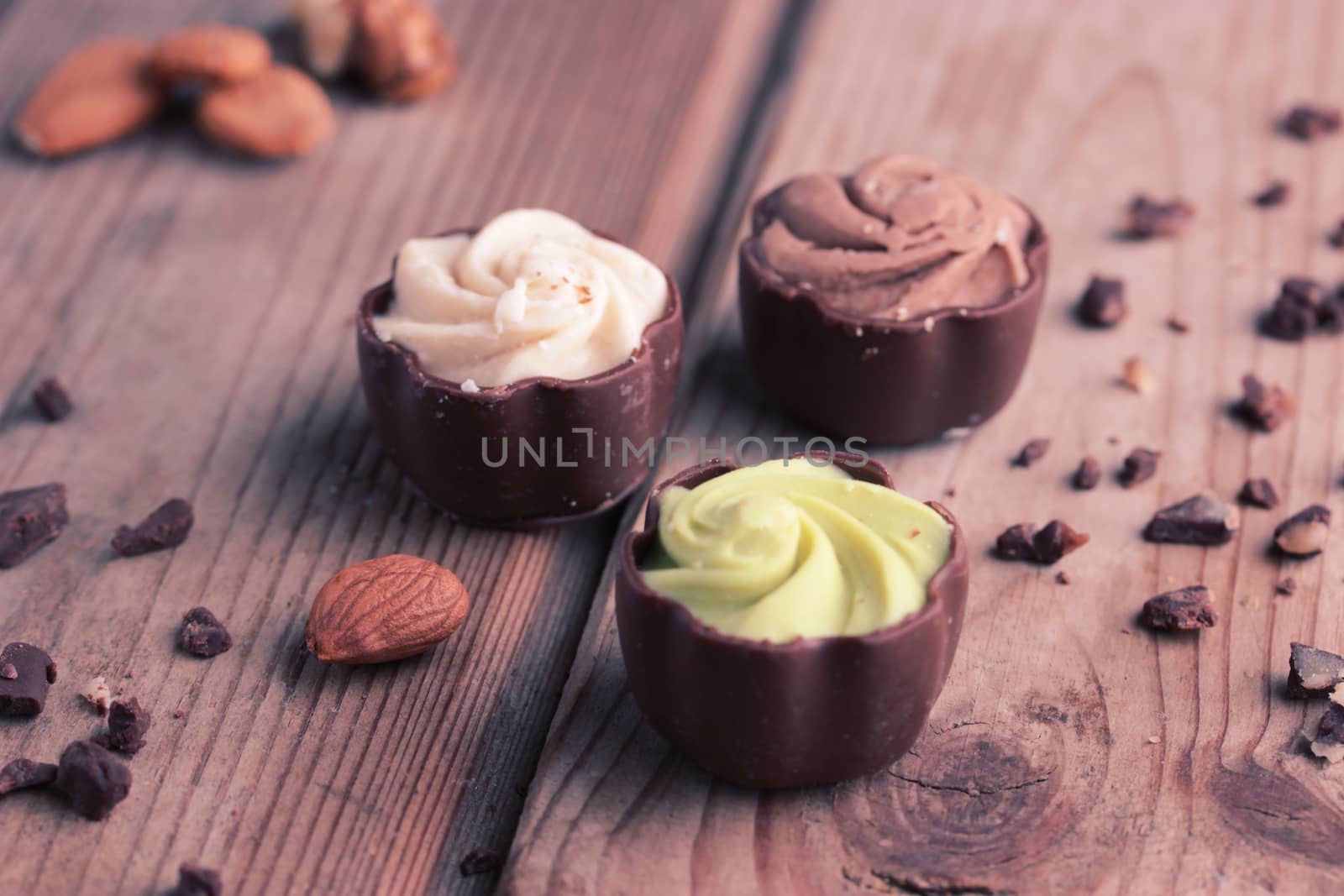 chocolate candy on wooden table by liwei12