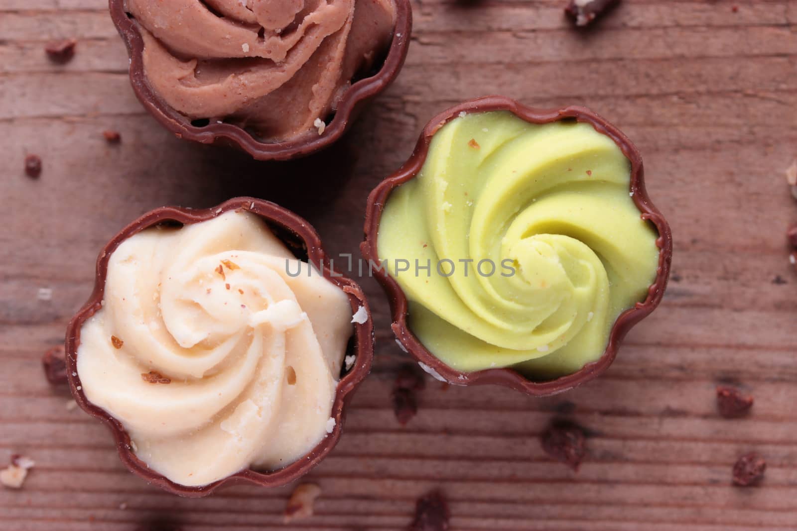 diffrent kinds of chocolate candy on wooden table