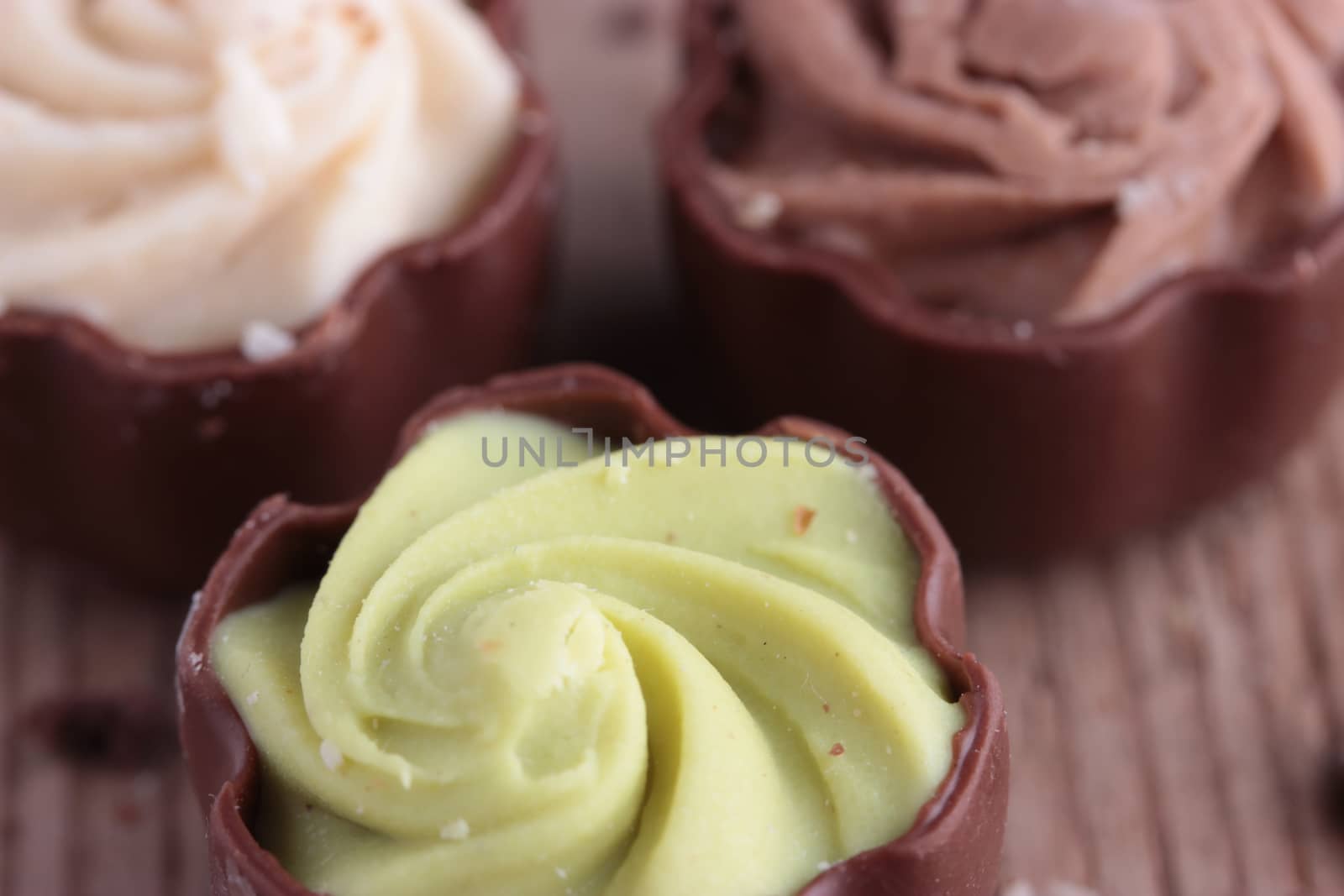 diffrent kinds of chocolate candy on wooden table