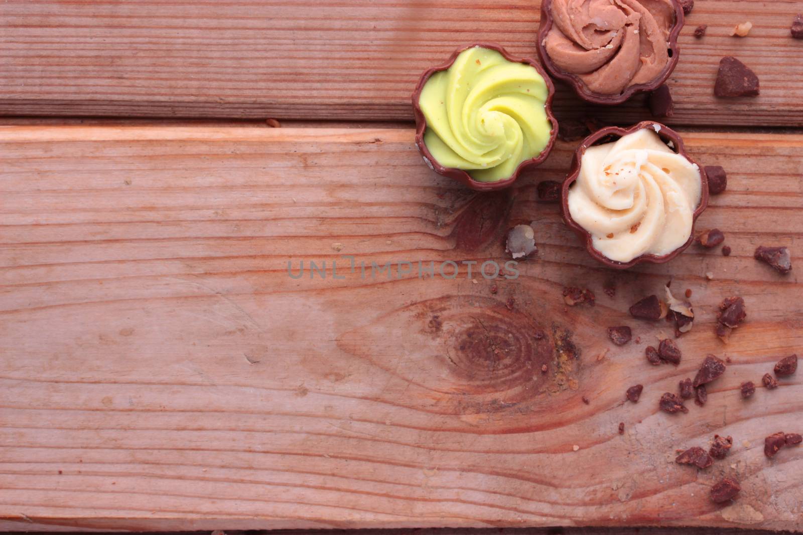 diffrent kinds of chocolate candy on wooden table