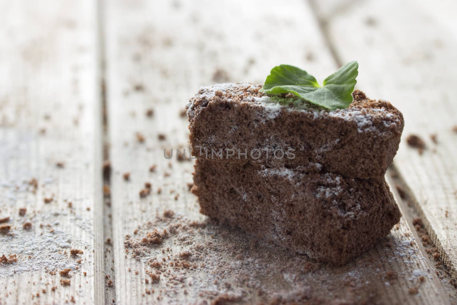 chocolate brownie and mint on wooden table