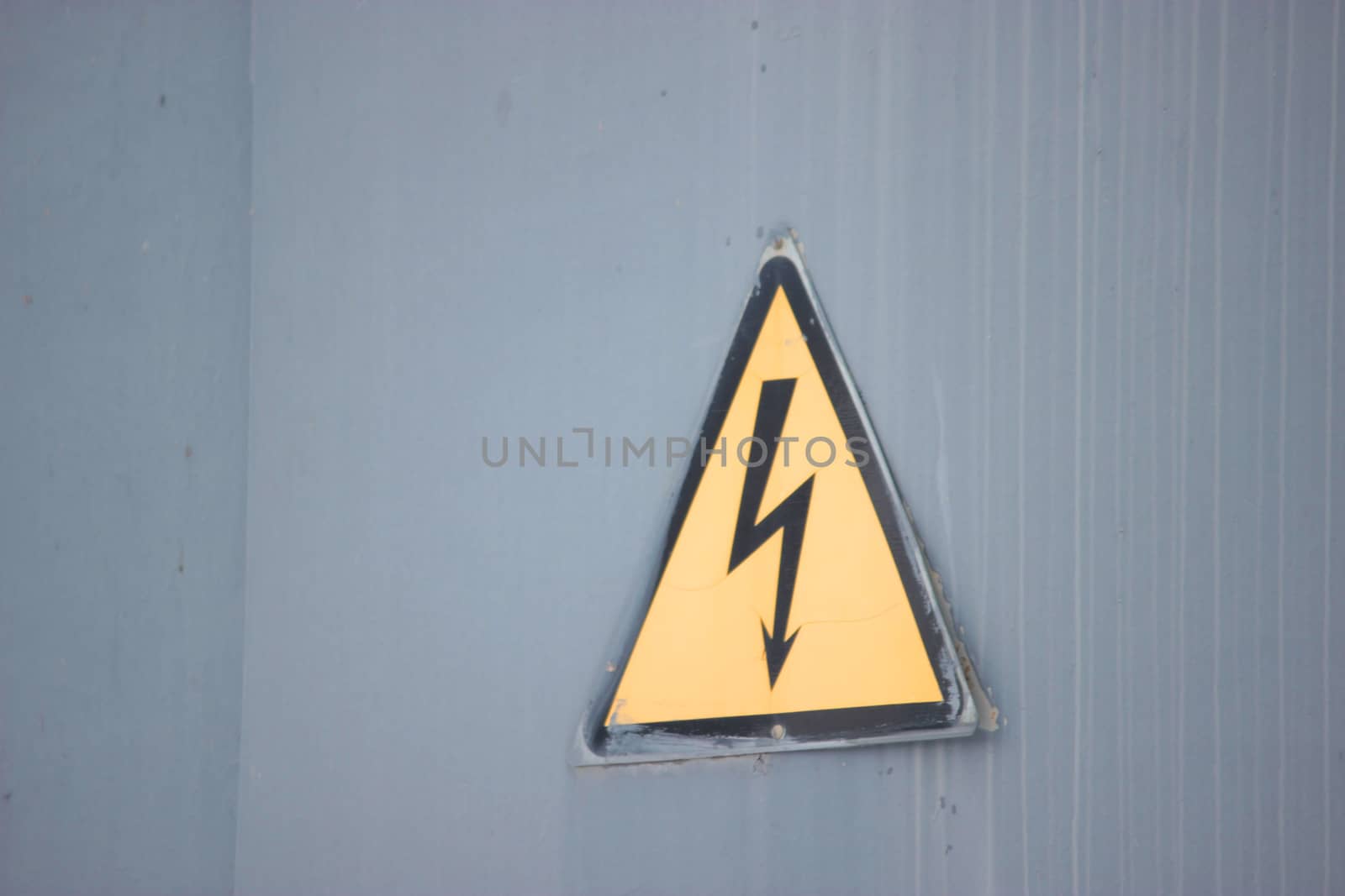 triangle yellow electricity sign on grey background