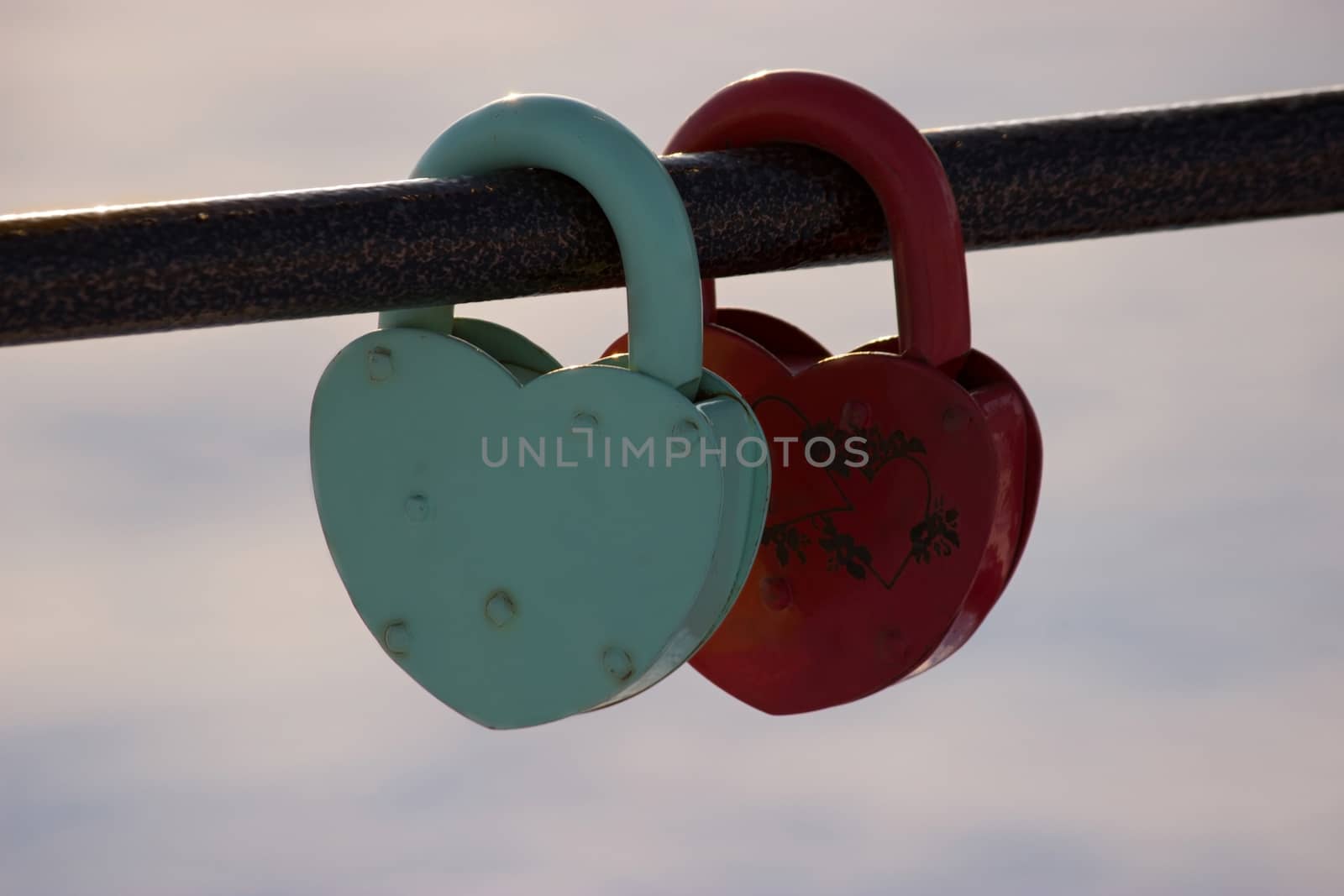 two heart shaped padlocks, beautiful sunset sunbeans