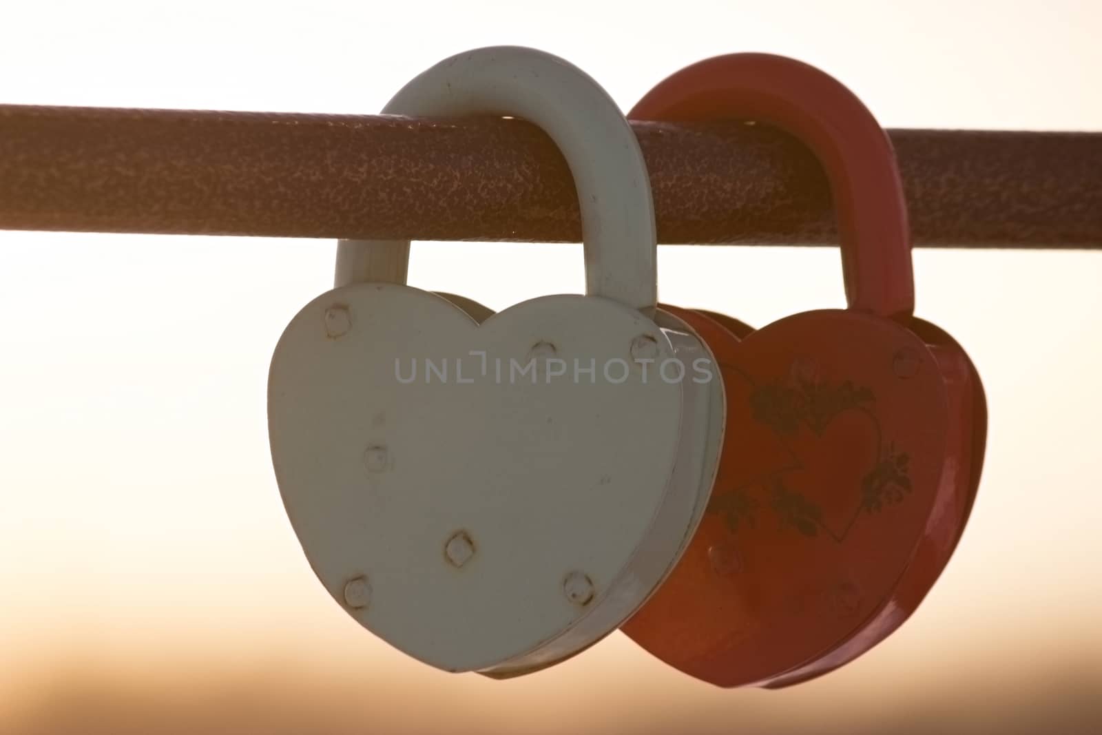 two heart shaped padlocks, beautiful sunset sunbeans