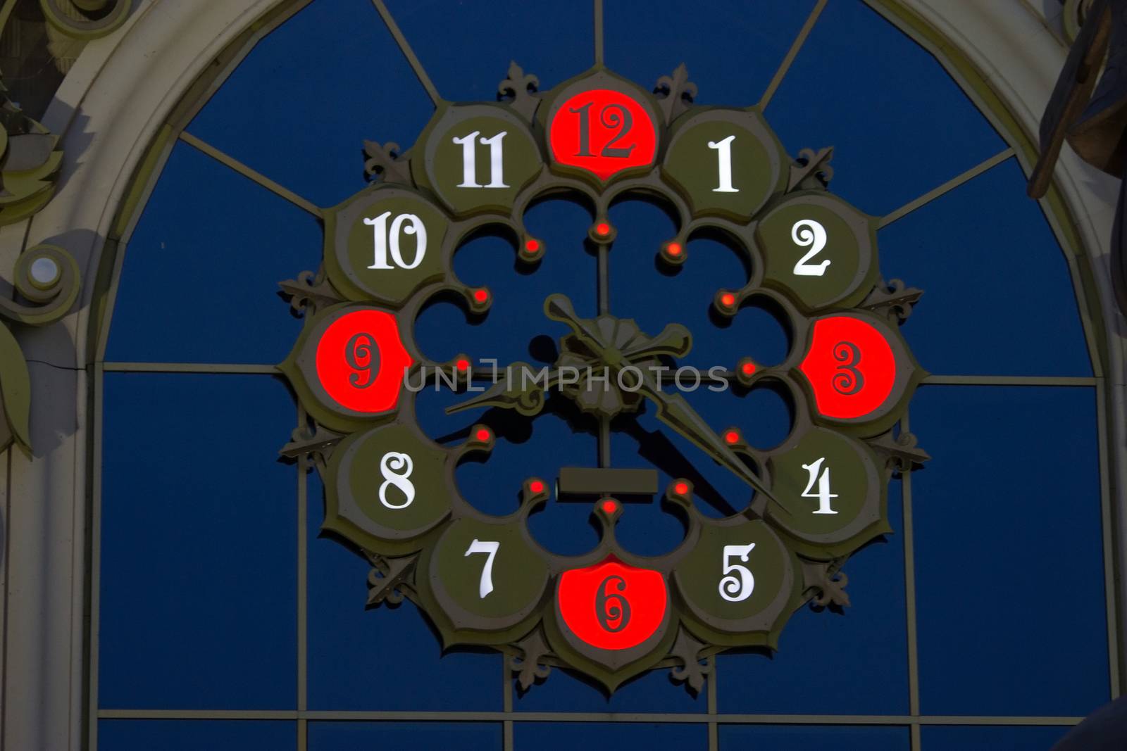 colorful illuminated clock with red numbers, night
