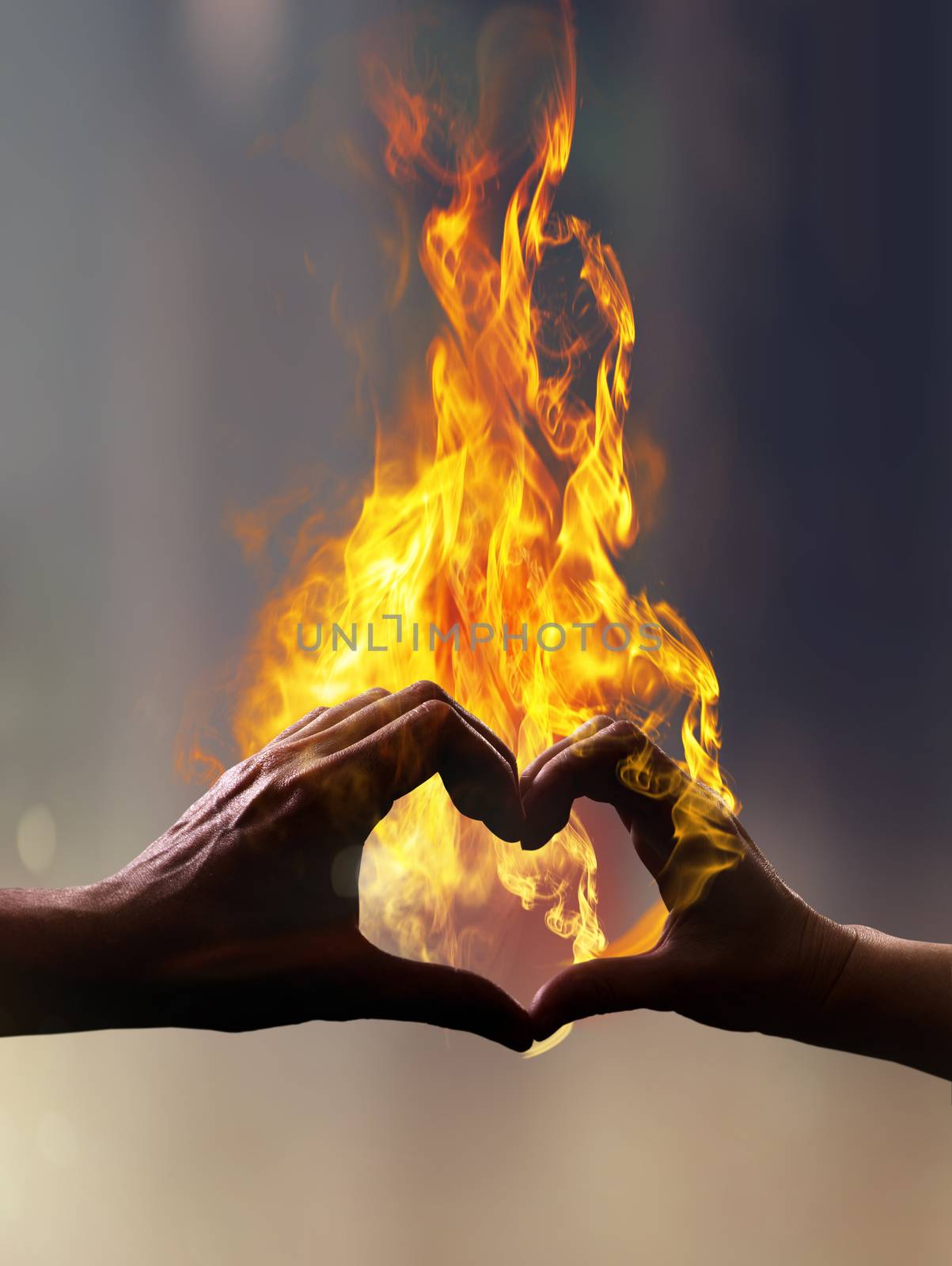 Silhouette of hands with fire in form of heart when sweethearts have touched