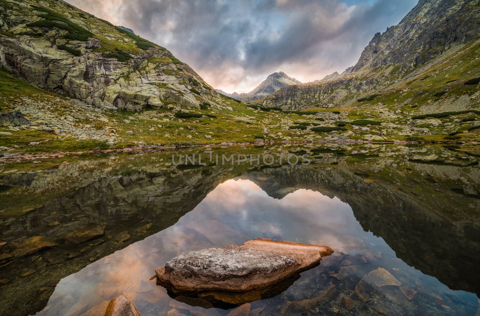 Mountain Lake Above Skok Waterfall with Rocks in Foreground and Strbsky Peak in Background at Sunset. Mlynicka Valley, High Tatra, Slovakia.