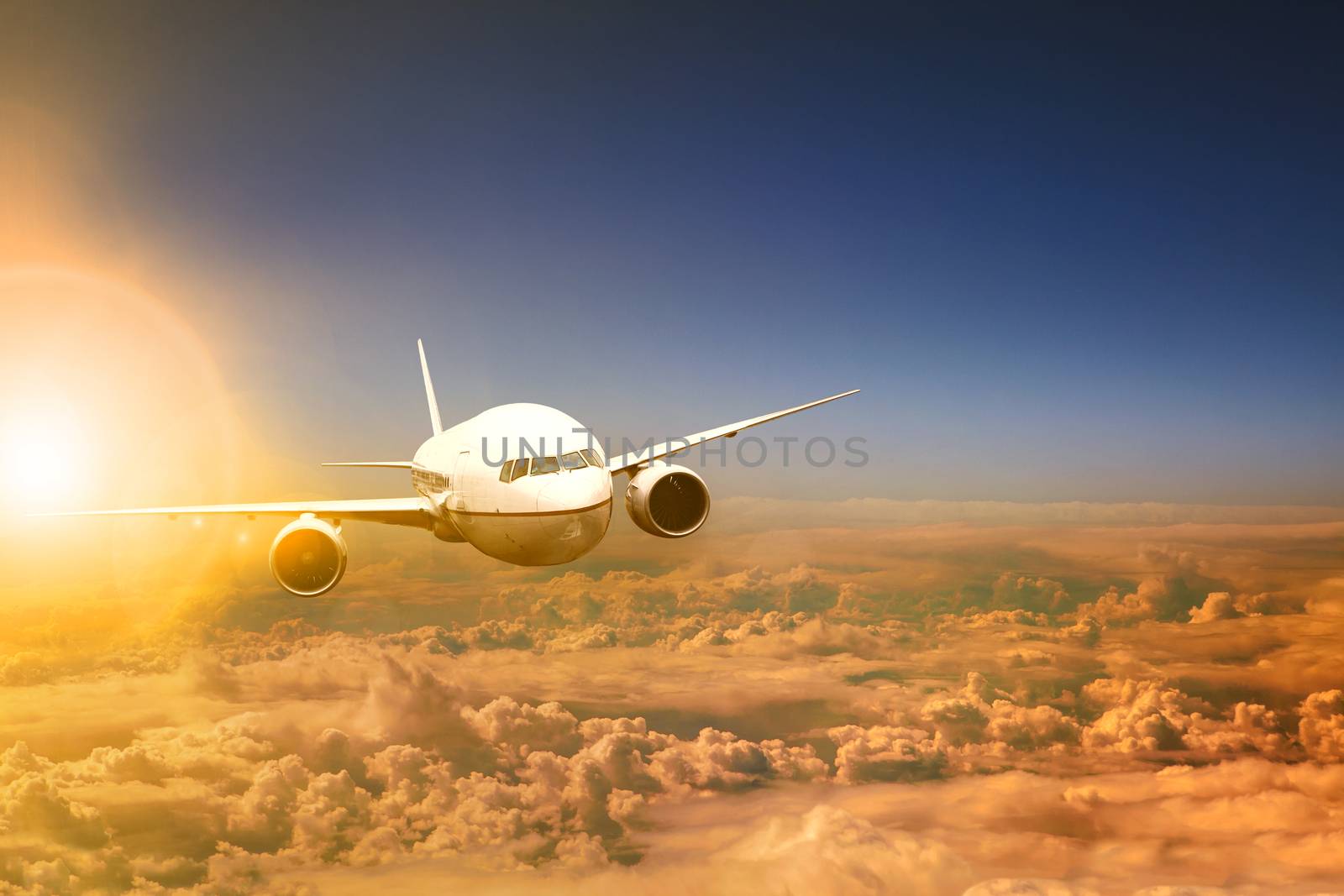 air plane flying over cloud scape and sun light behind by khunaspix