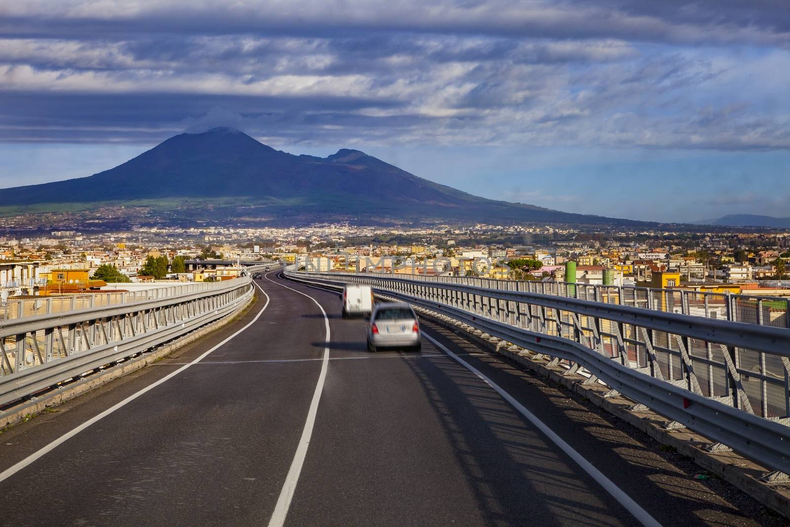 A one motorway from naple to rome passing naple town and vesuvius volcano scene