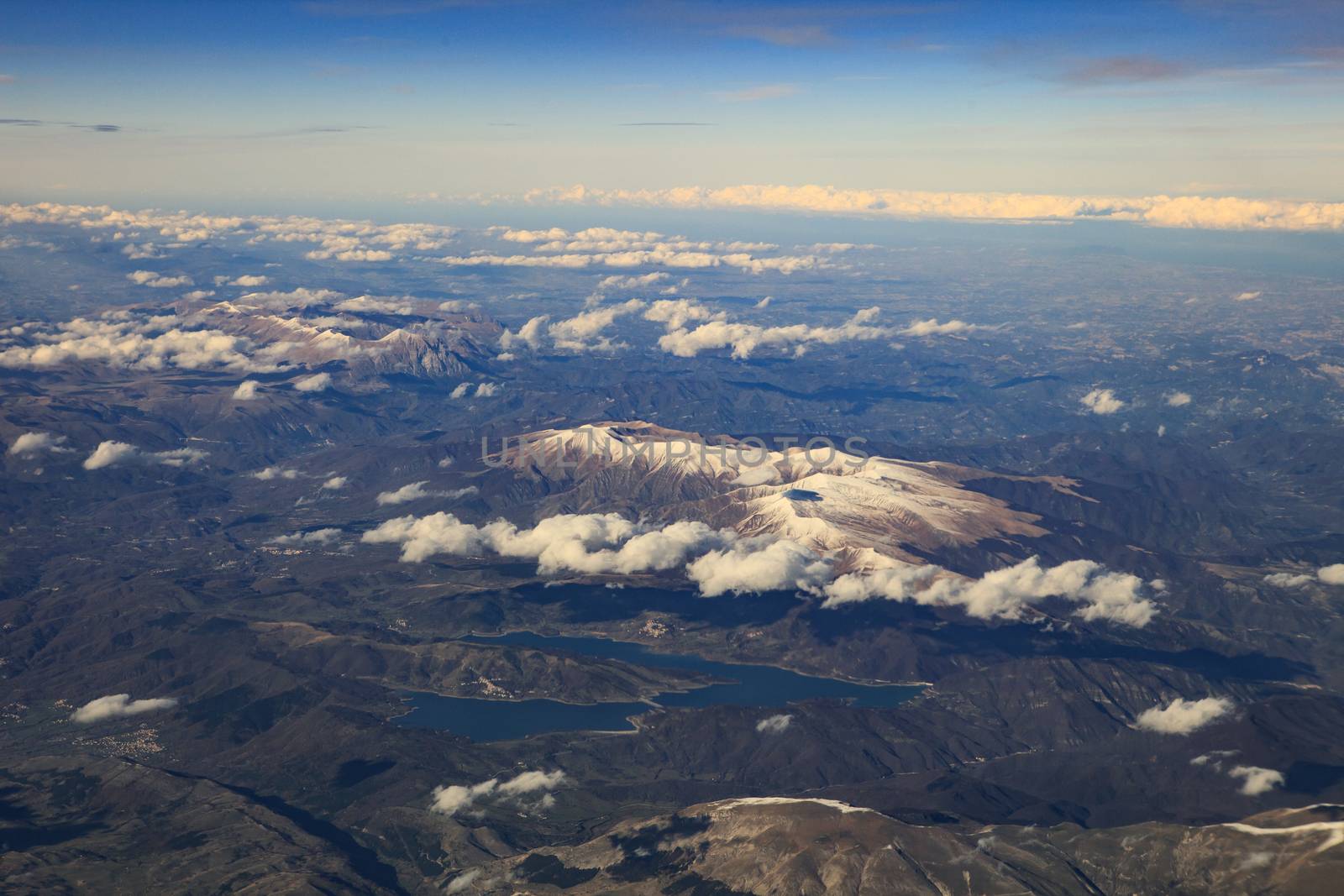 landscape from plane window of high mountain in italy after plane taking from Fiumicino Leonardo da Vinci International Airport 