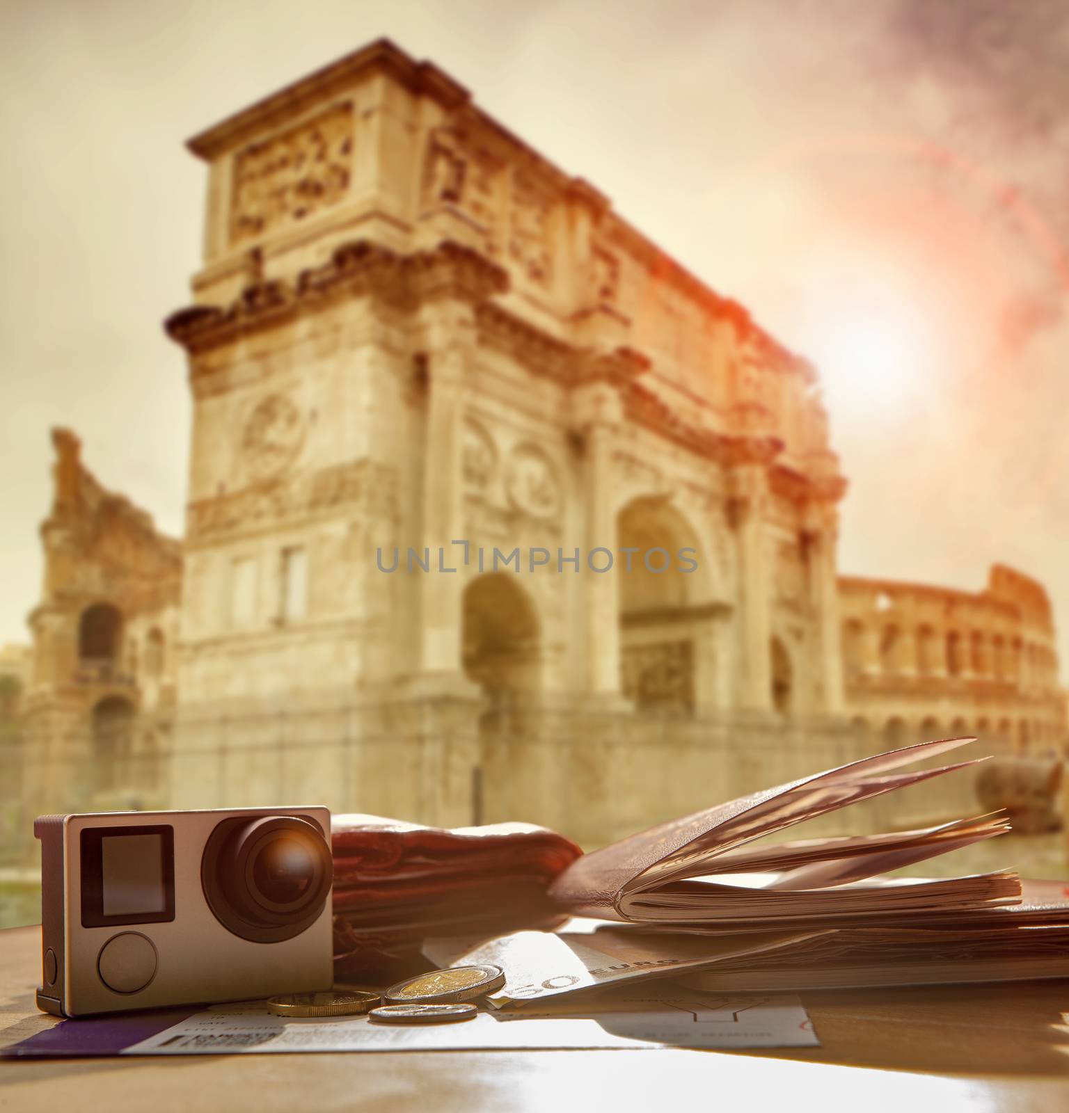 passport ,traveling boarding pass ,euro money and easy camera  on wood table against sun light at Arch of Constantine colosseum rome italy