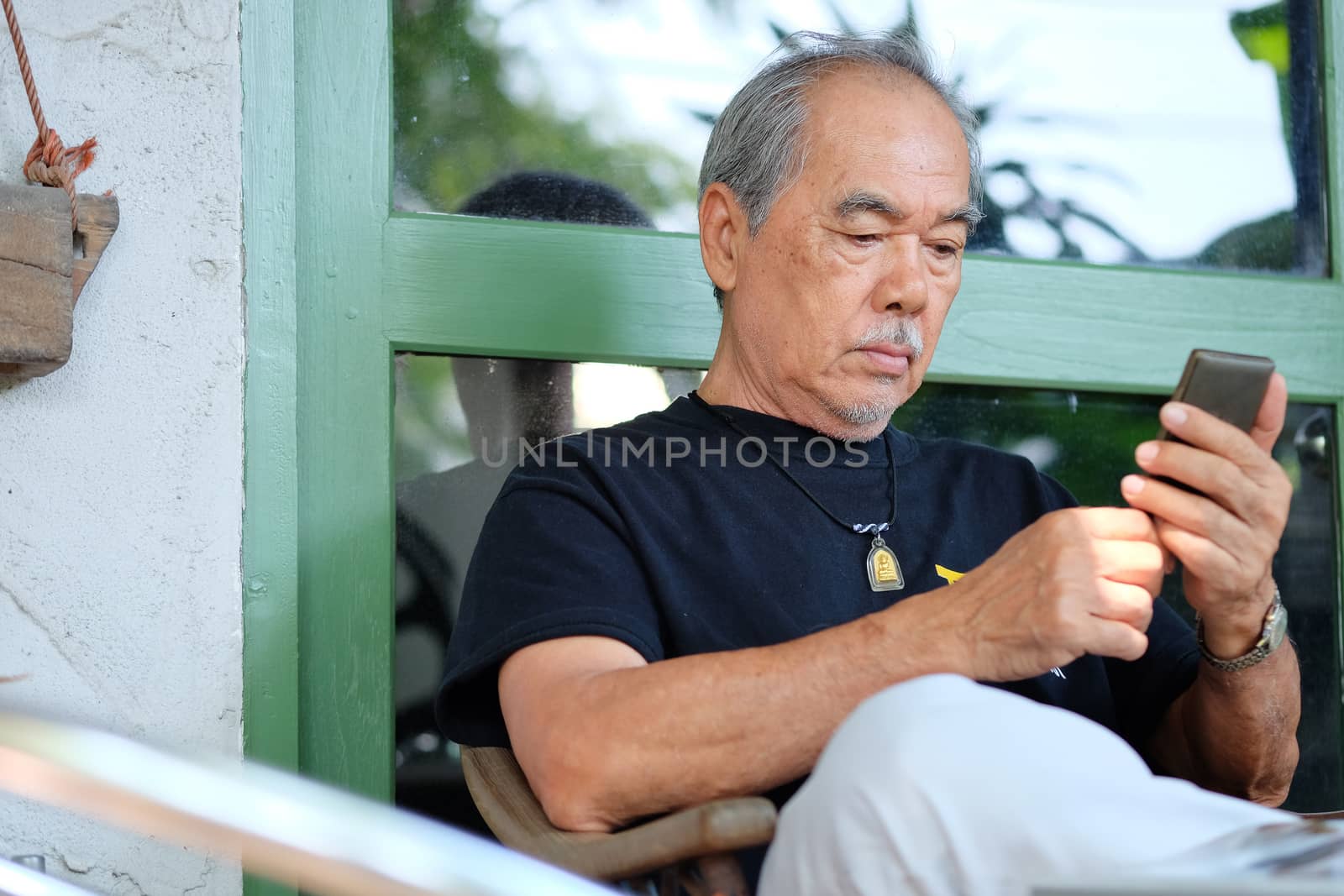 senior man enjoying on his phone