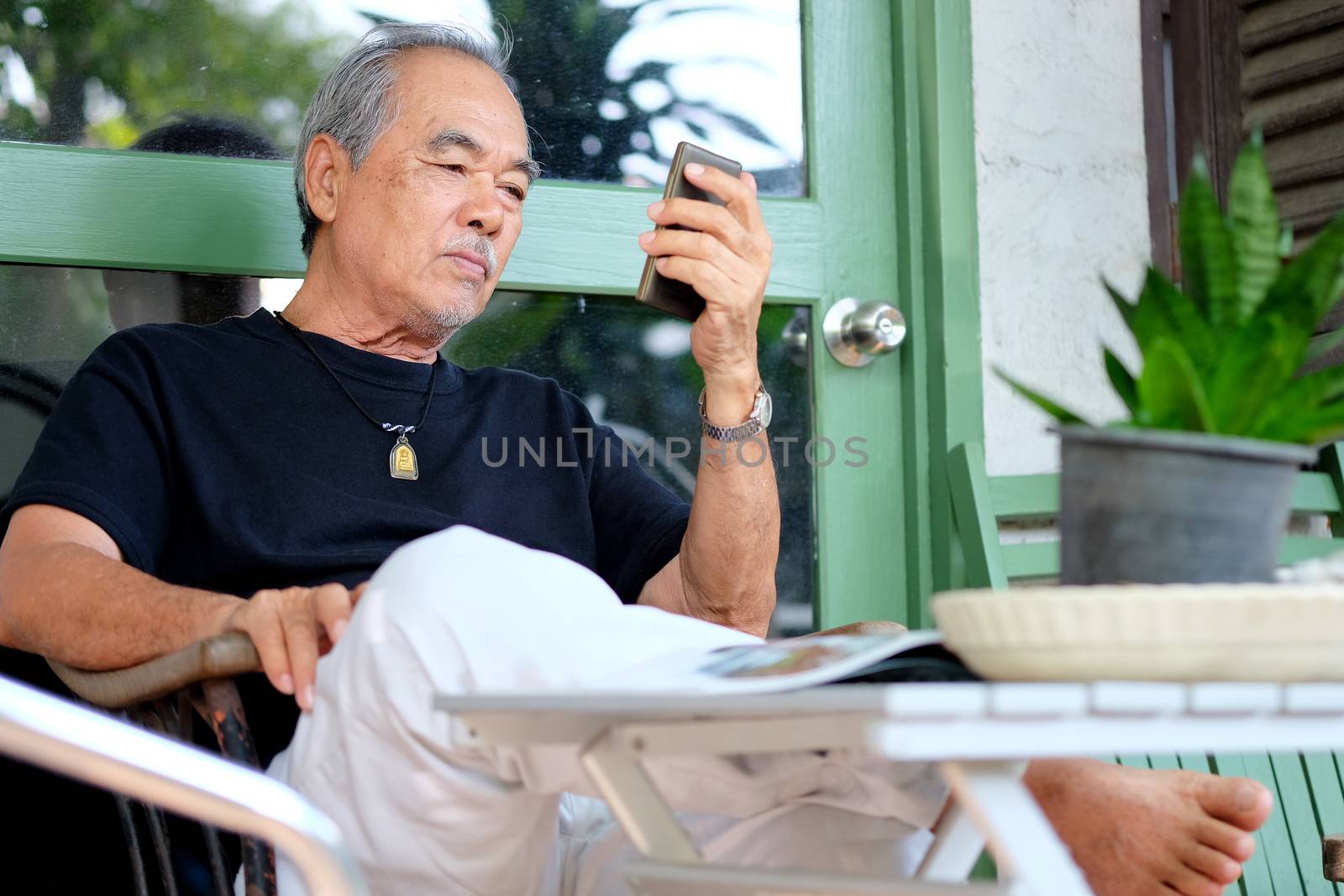 senior man enjoying on his phone