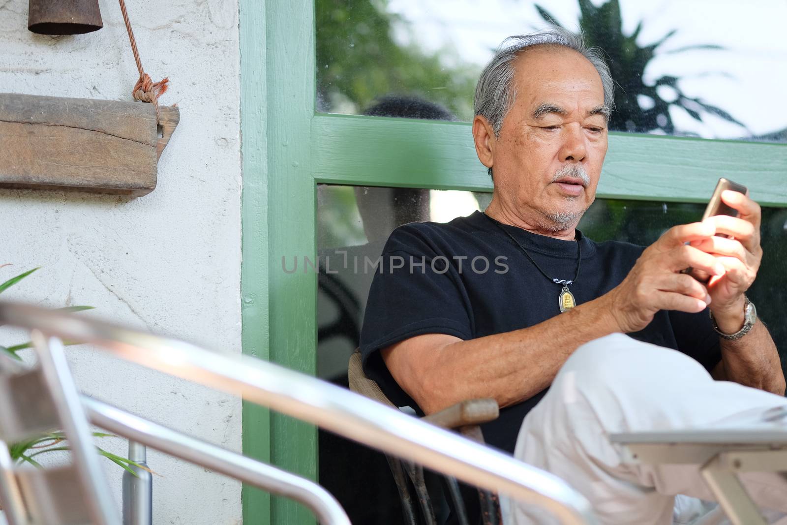 Senior man relaxing at home by ponsulak