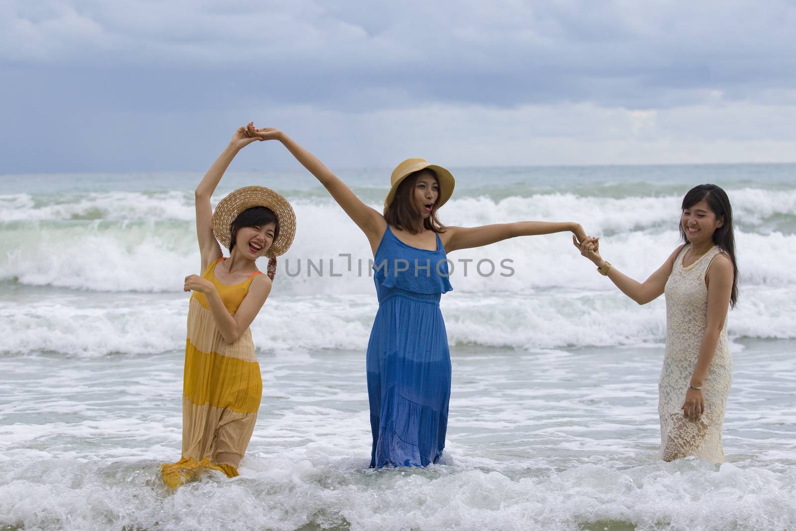 younger asian woman relaixng vacation time at sea beach happines by khunaspix