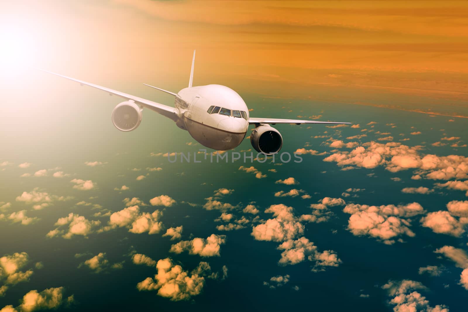 passenger  plane flying over beautiful light sky for air traveli by khunaspix