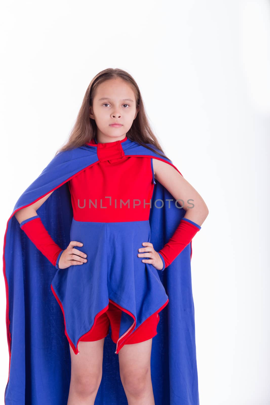 Girl in blue and red superhero costume with hands on hips