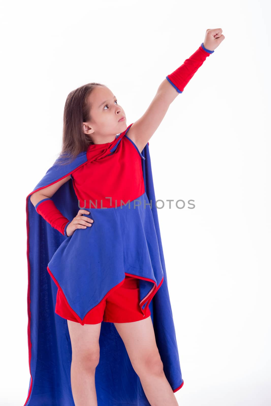 Girl in blue and red superhero costume holding arm up