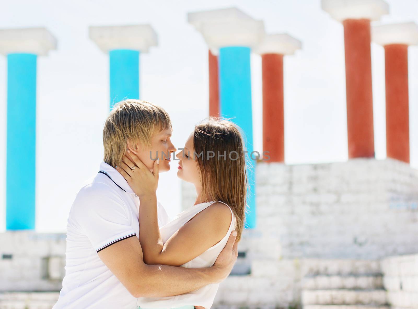 Young couple in love kissing. Lovers man and woman kissing and cuddling.