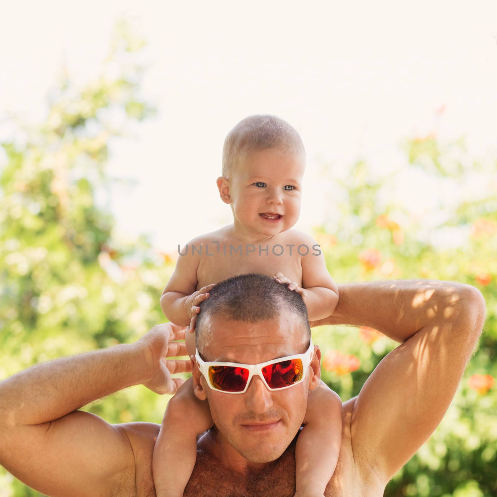 Portrait of happy father and his adorable little daughter outdoors.