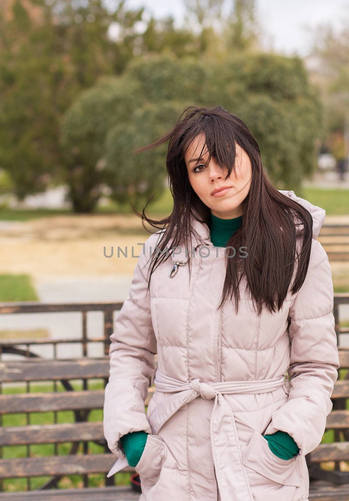 Portrait of pensive urban girl walking in city park