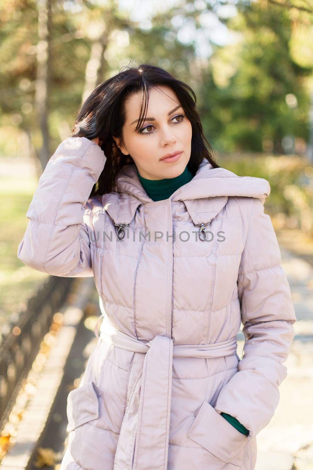 Portrait of pensive urban girl walking in city park