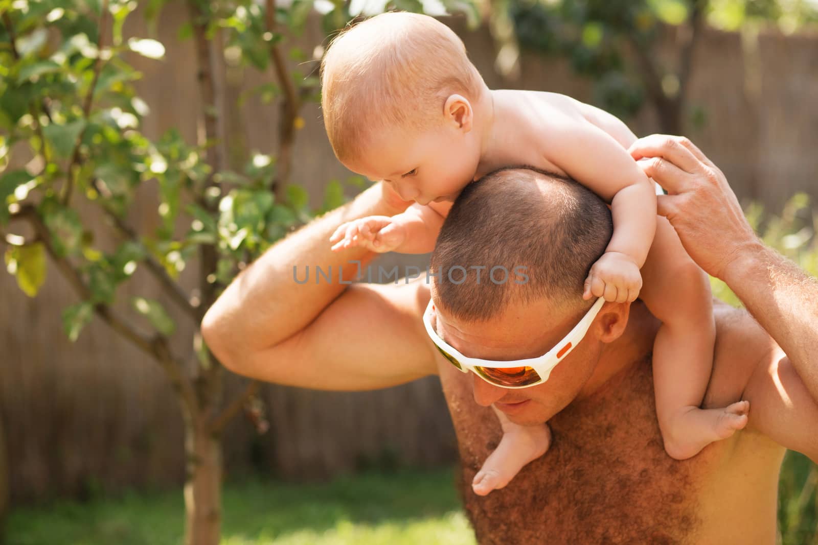 Portrait of happy father and his adorable little daughter outdoors.