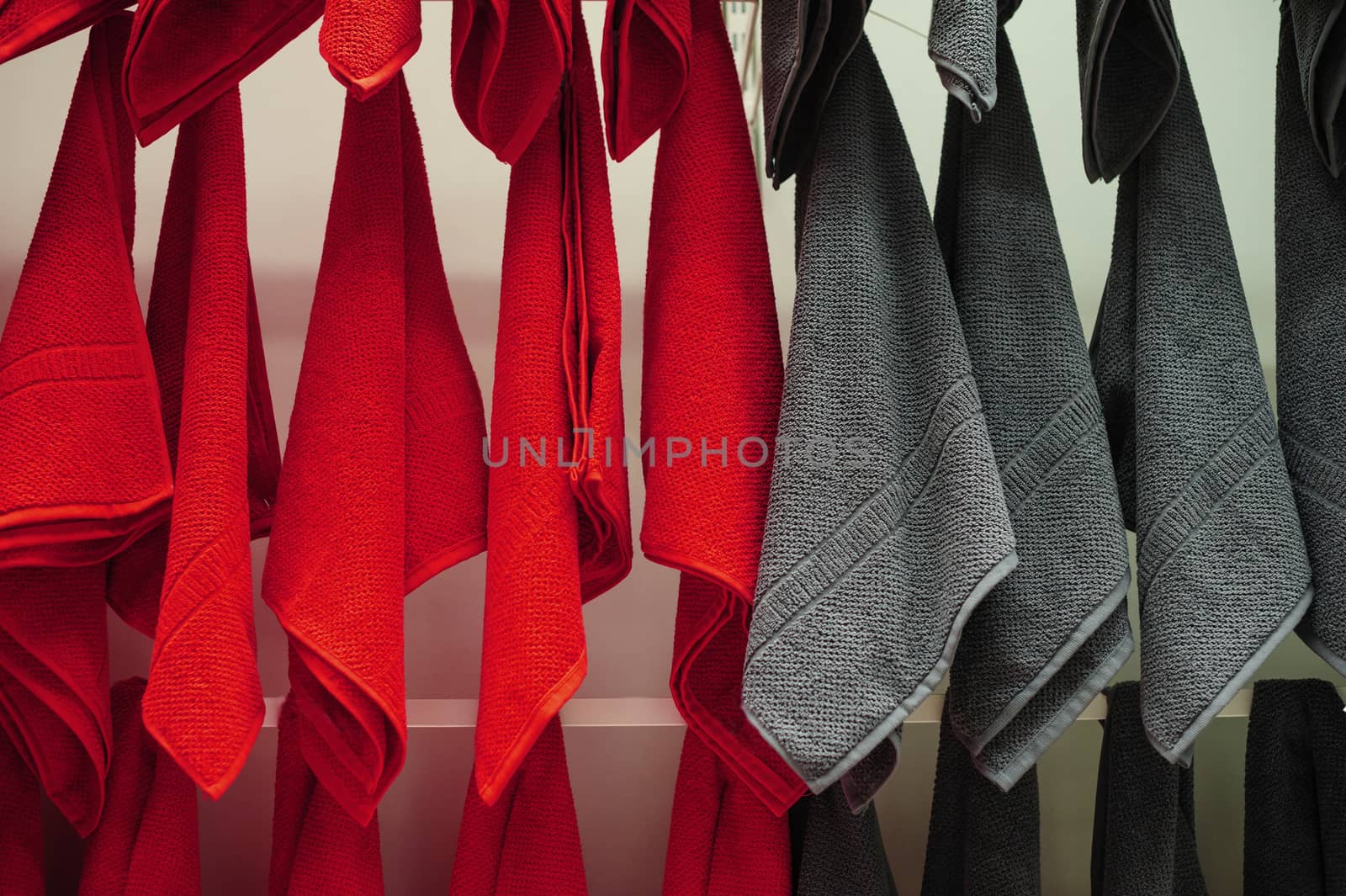 Red and gray towels in shop for sale.