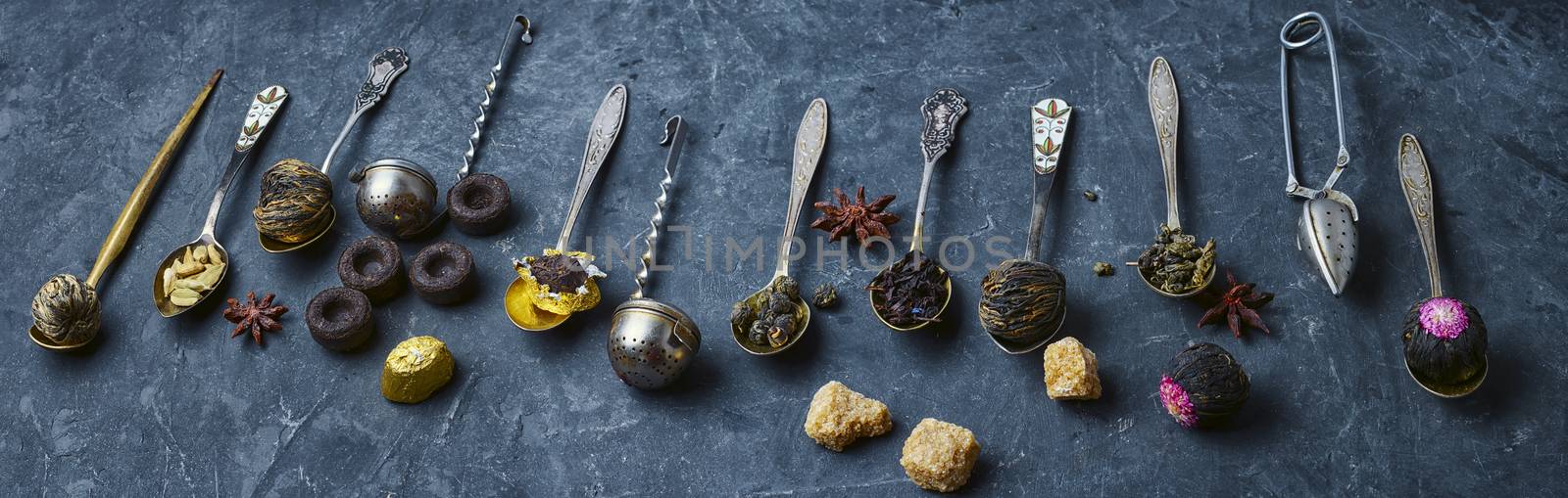 banner of tea leaves in a stylish tea boxes on slate concrete background