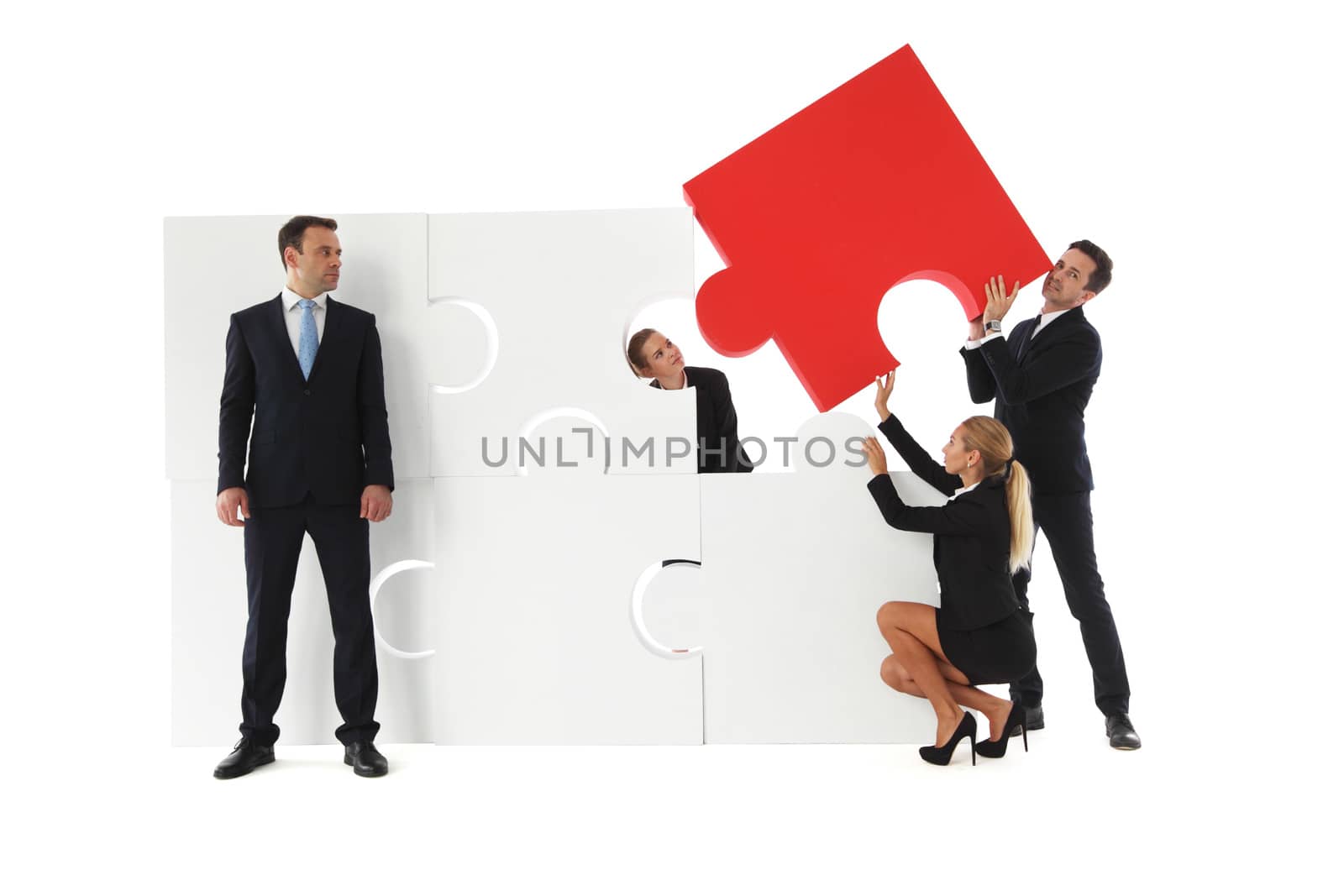 Business teamwork building big puzzle isolated on white background