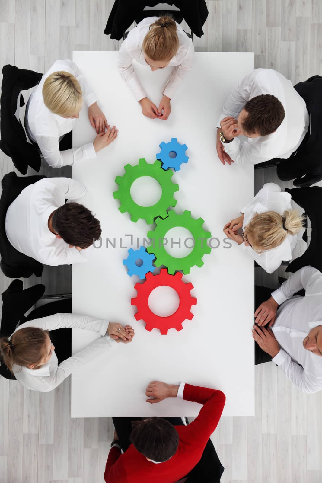 Business team with cogs by ALotOfPeople