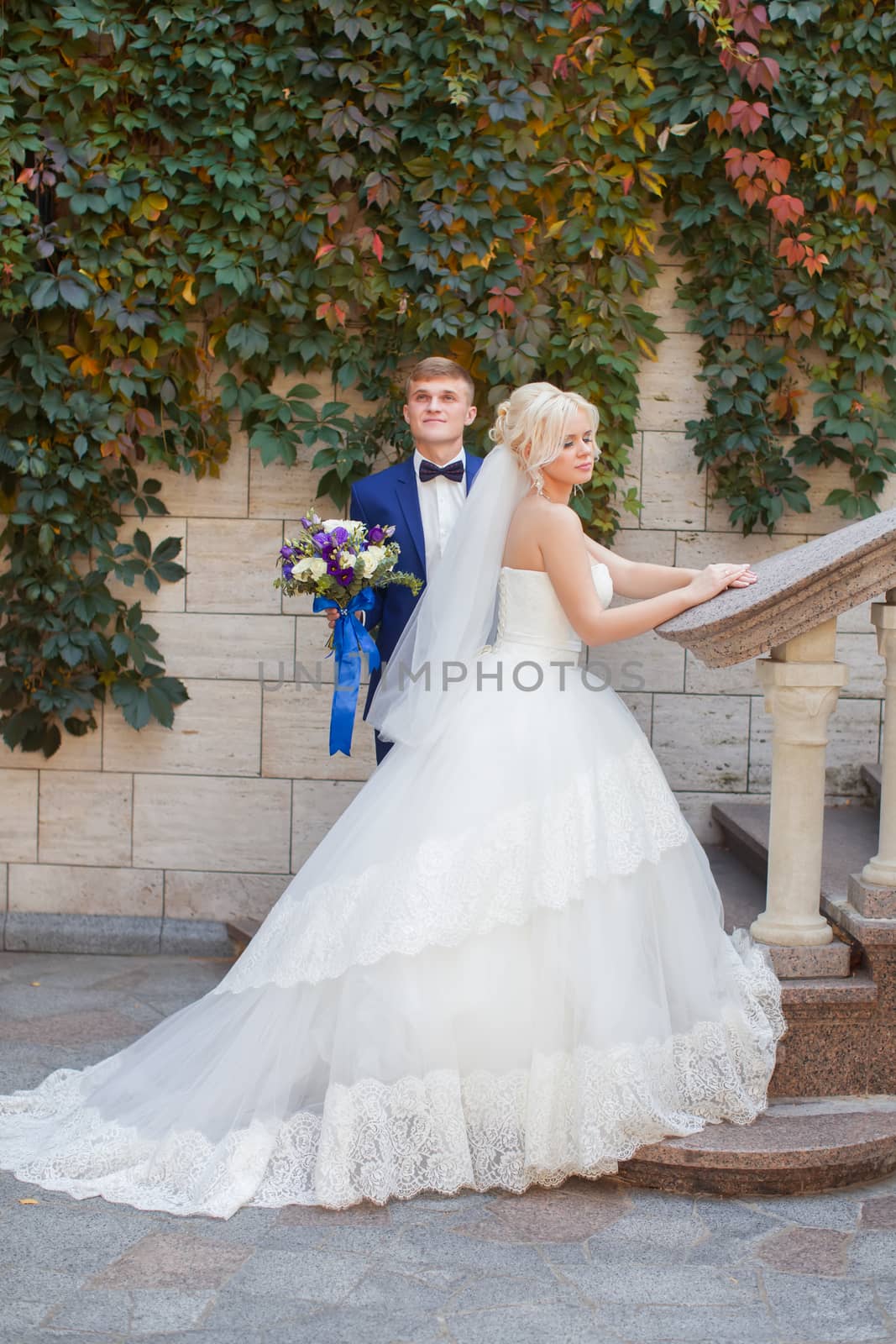 Stylish newlyweds posing for a walk in the photo by lanser314