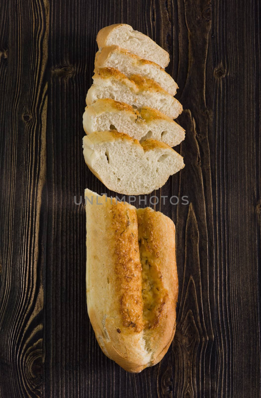 Top view of a sliced of baguette with cheese by kzen